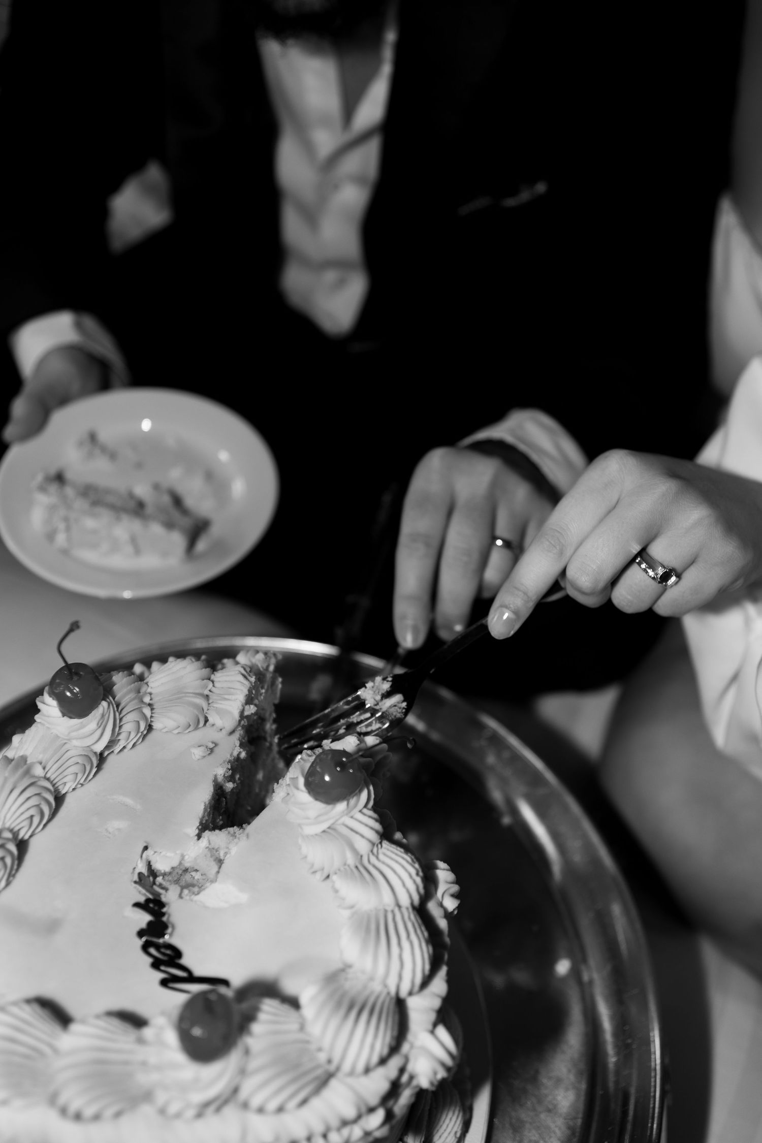 bride and groom eating their wedding cake together at crathorne hall on their wedding day