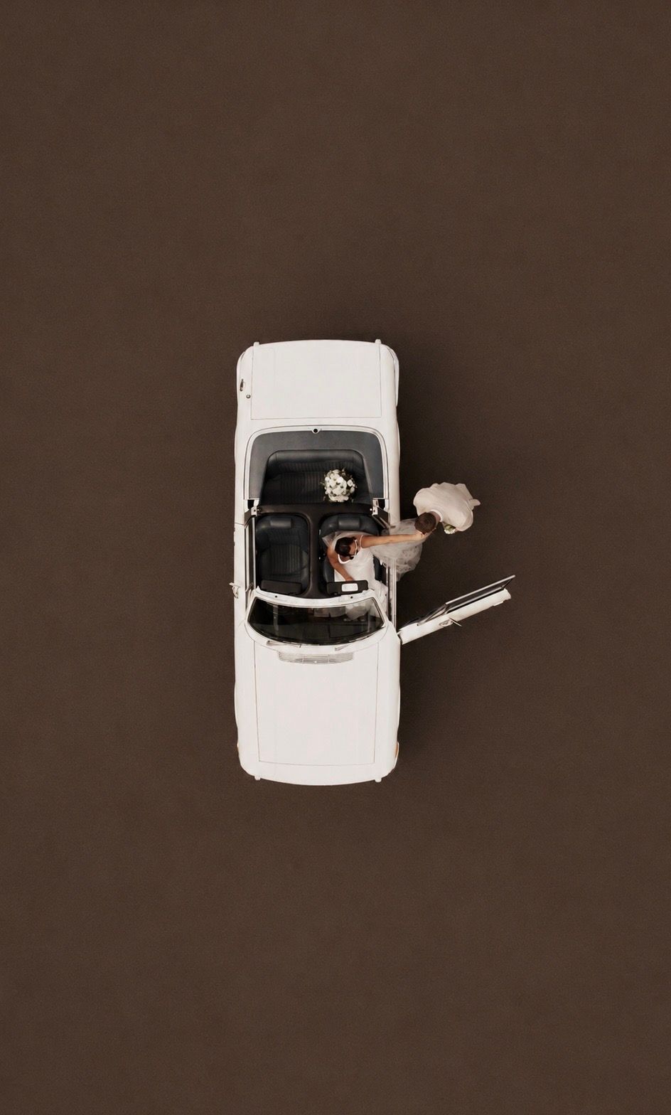 drone image of wedding couple getting out of wedding car during their wedding at the hidden oak located in Stockton on tees