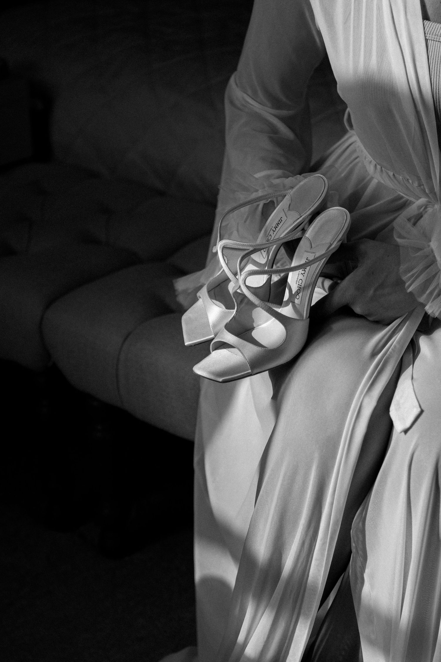 black and white dark exposure of bridal prep shows with rays of sunlight hitting them