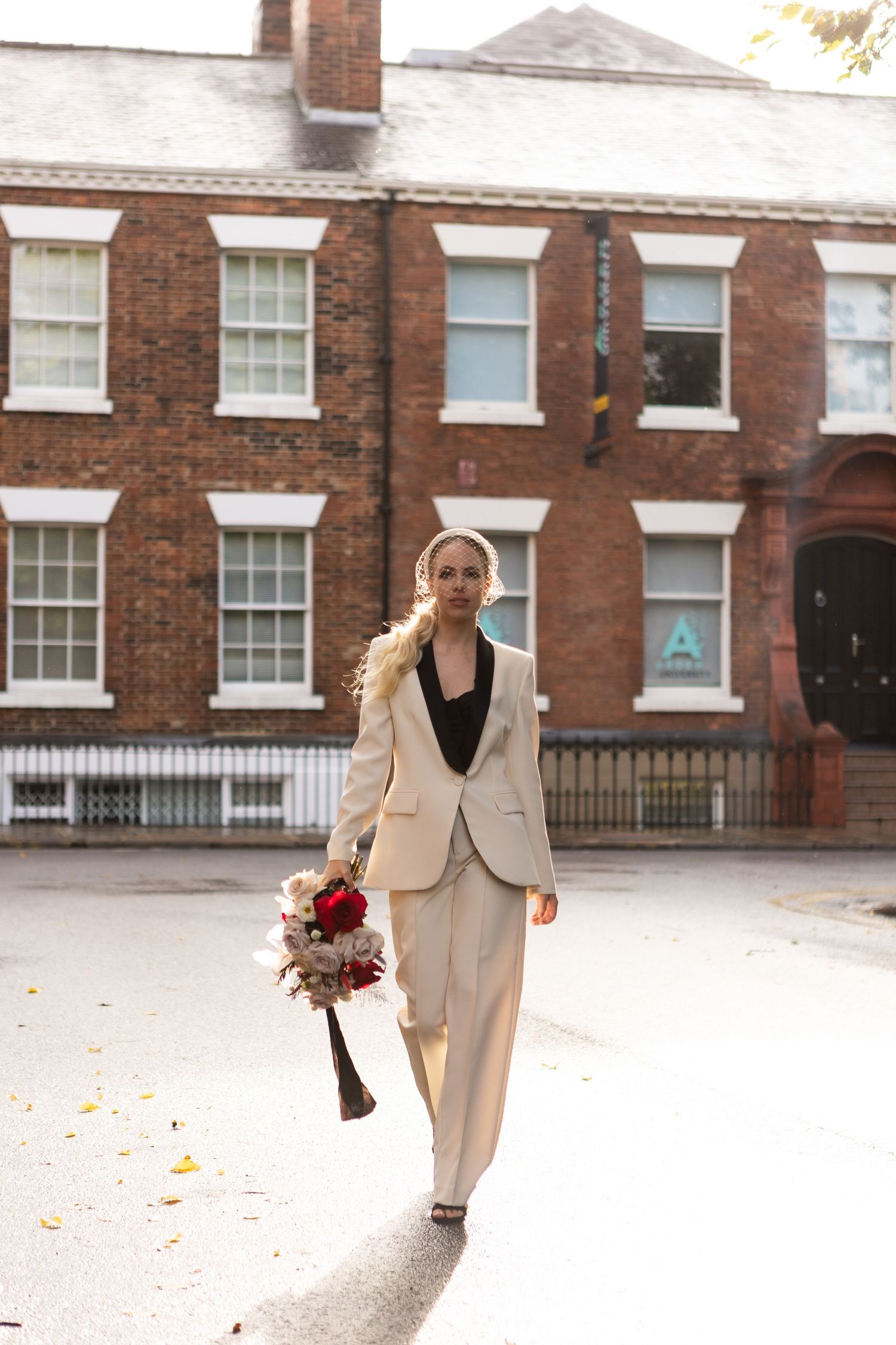 Bride in bridal suit strutting through the streets on her wedding day