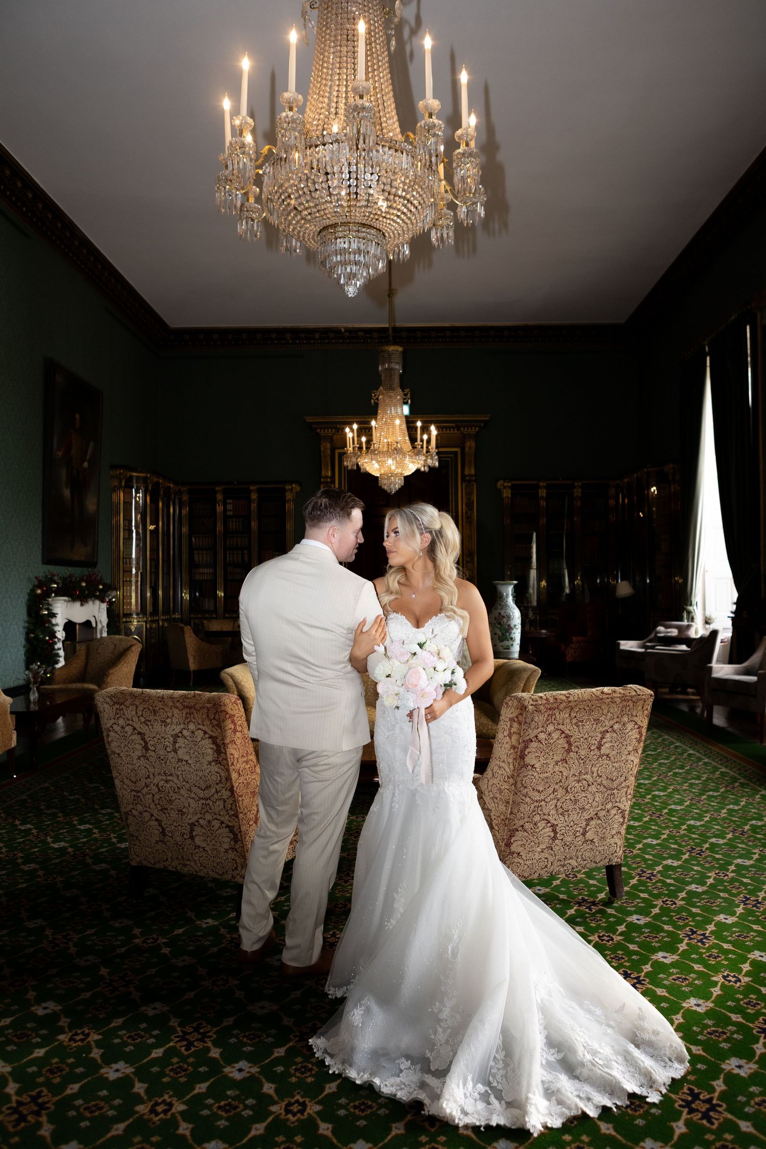 bride and groom posing in vintage sitting room of Wynyard hall wedding venue editorial style image
