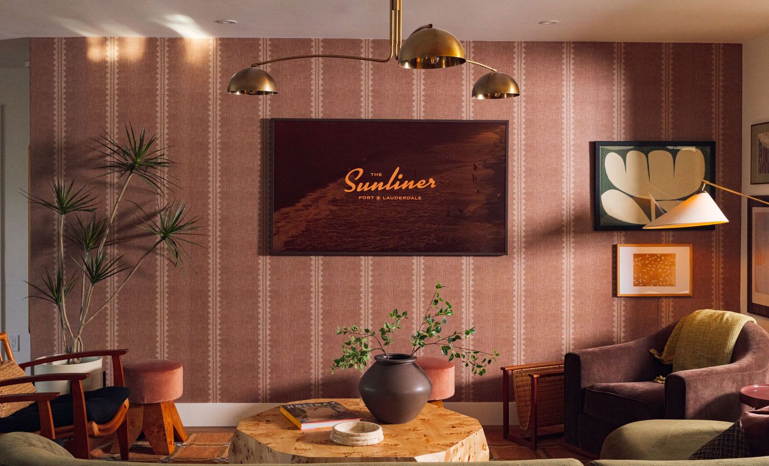 South Florida interior design photography of a retro lounge with warm textures, sculptural lighting and layered decor.