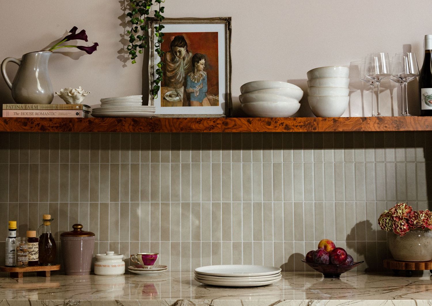 Styled product photography of handcrafted ceramic bowls and plates displayed on open kitchen shelves with romantic home décor.