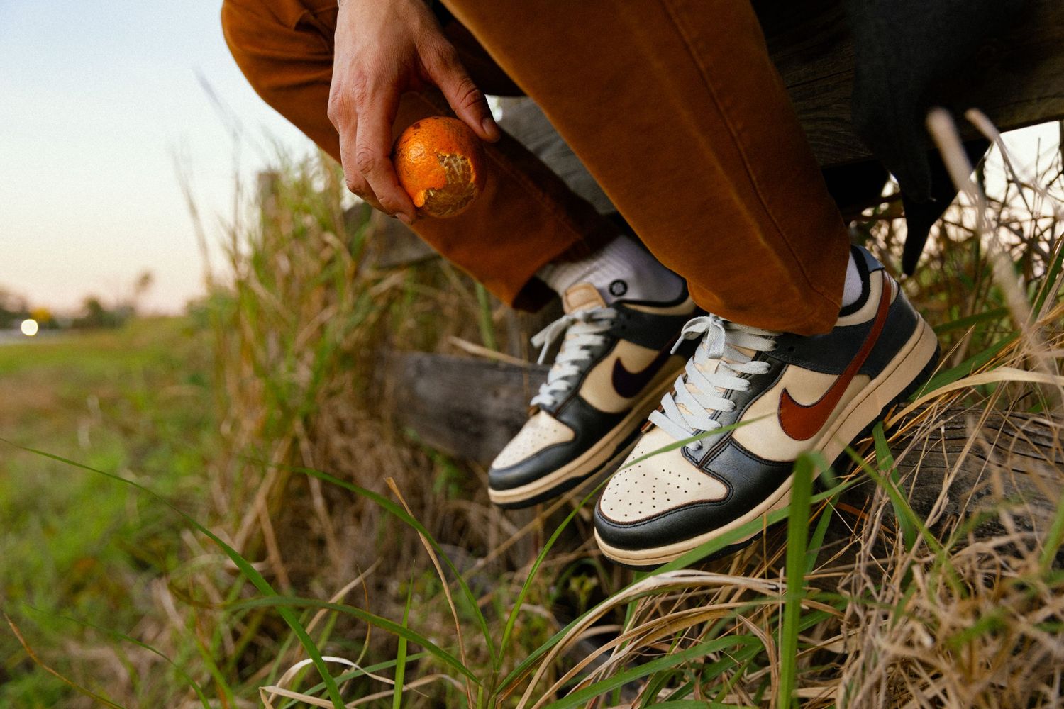 Lifestyle product photography of custom Nike dunks worn by male model on location photoshoot