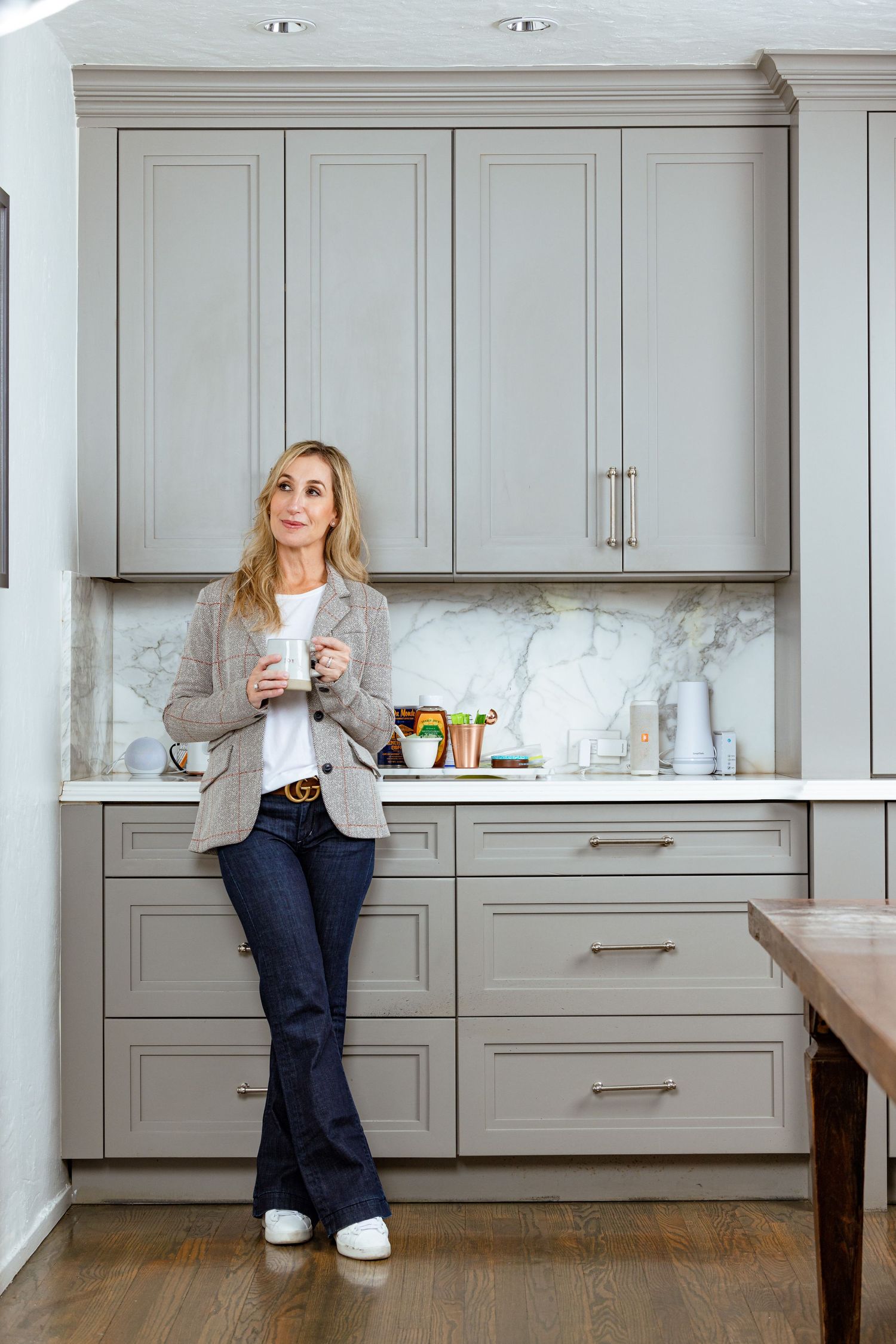 South Florida luxury realtor personal branding photo in upscale kitchen, showcasing real estate agent lifestyle and home marketing presence.