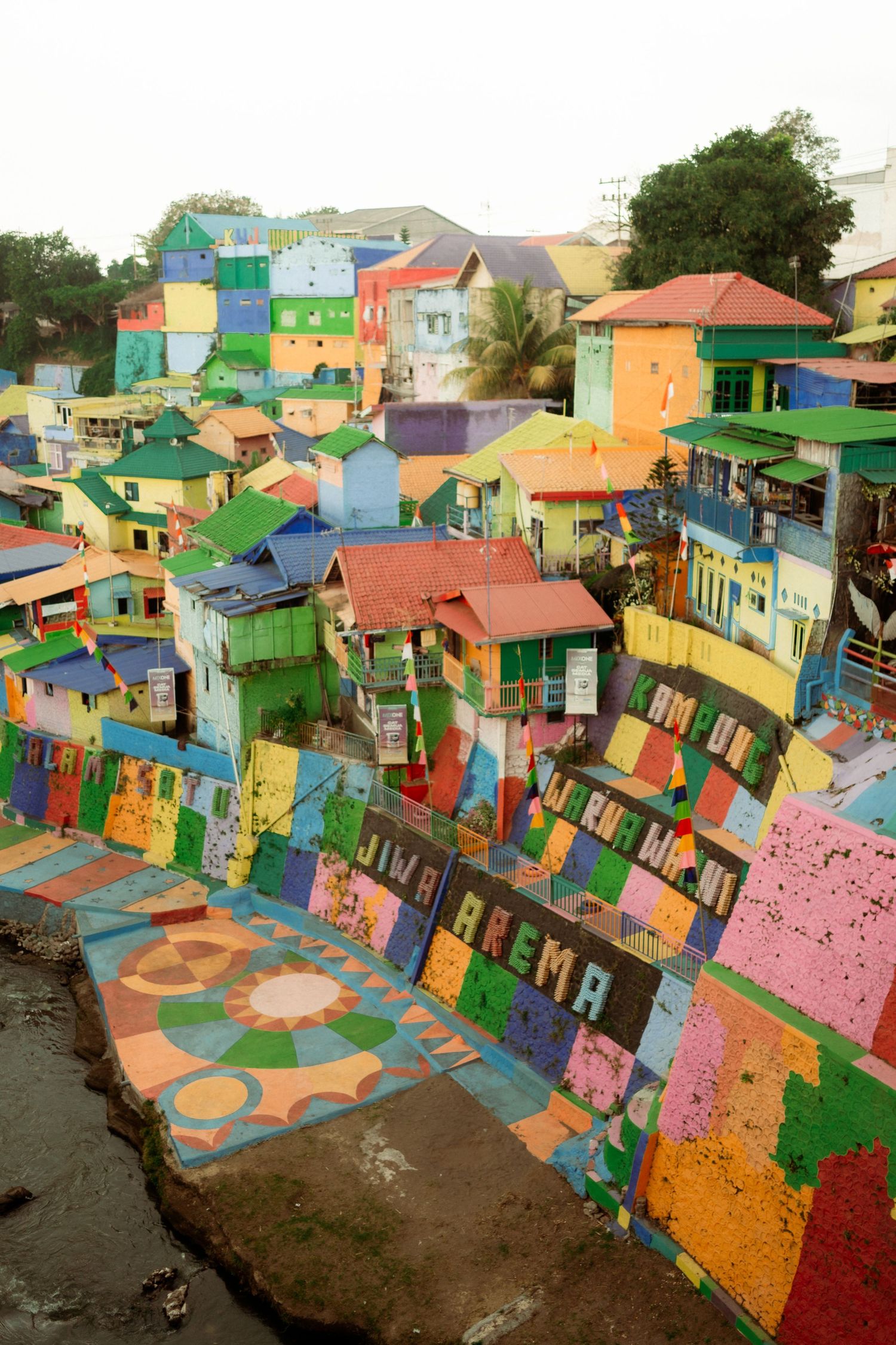 Colorful vibrant painted houses and buildings covering hillside in Kampung Warna-Warni Jodipan, Malang Indonesia.