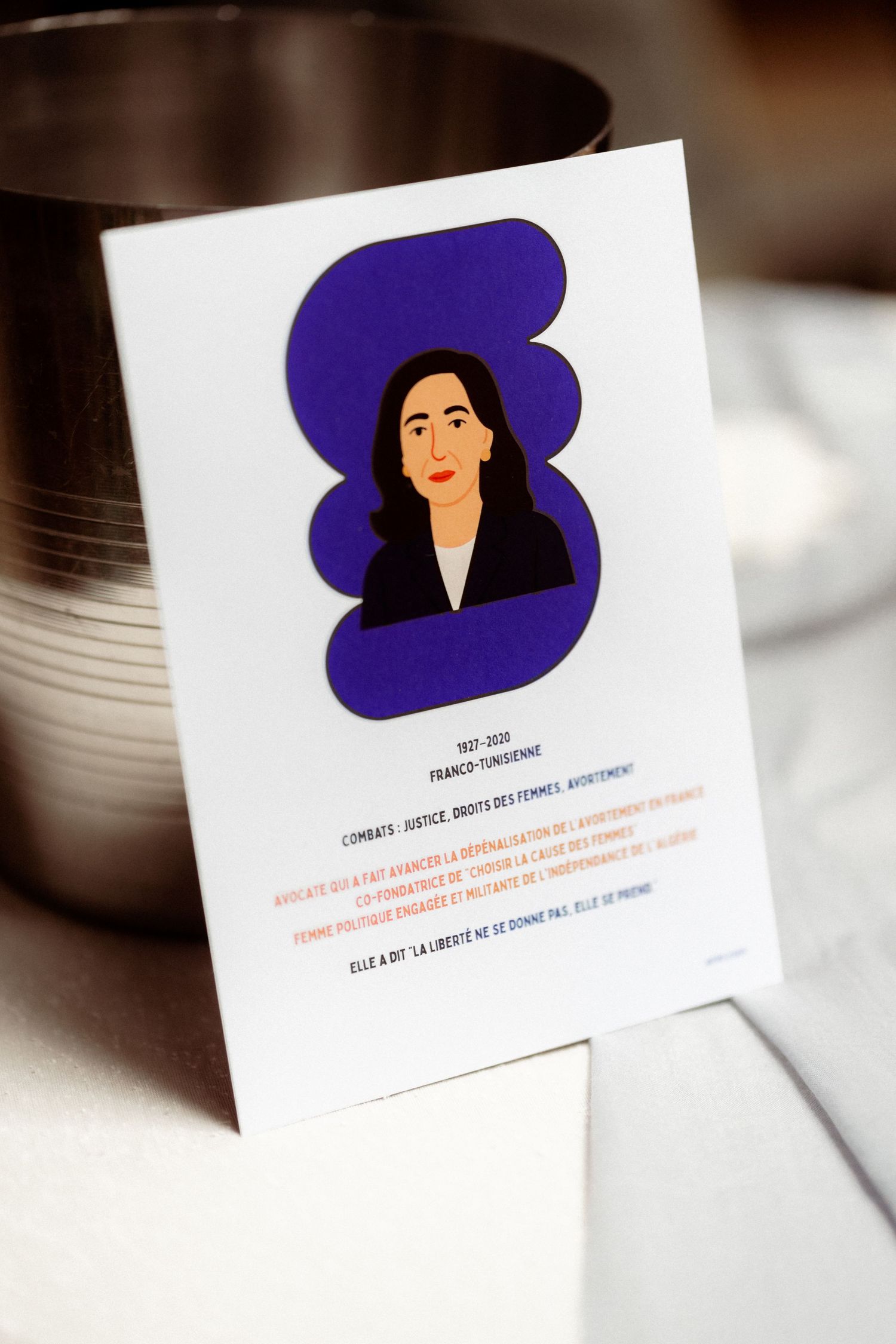 Illustrated card featuring a Franco-Tunisian woman portrait with purple background and French text about her legacy.