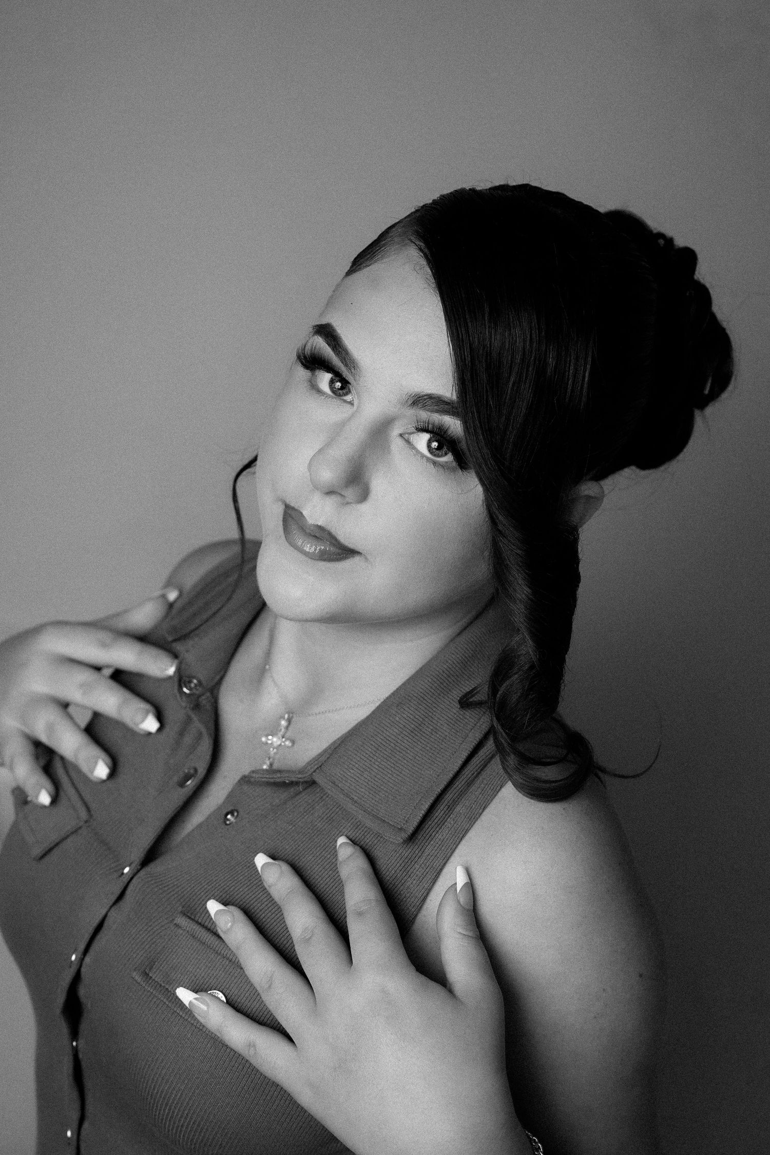 Black and white artistic portrait series showing dramatic angles and poses with dark lipstick and upswept hairstyle.