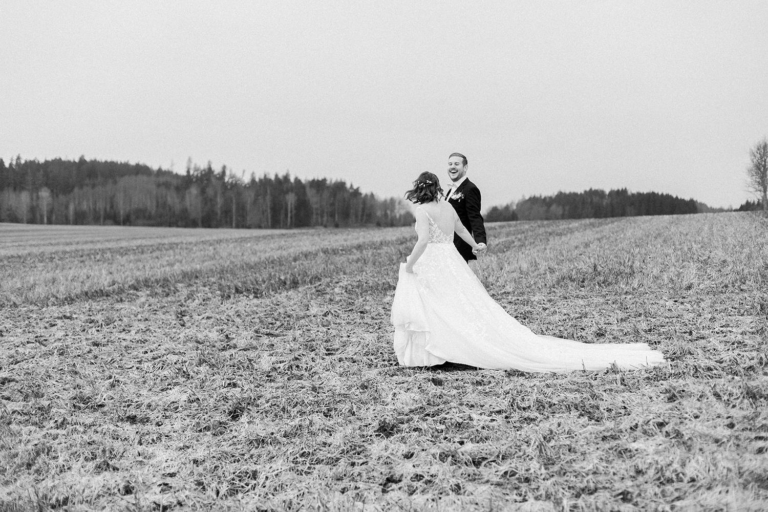 A series of black and white photos showing a couple sitting in a snowy field wearing winter attire.
