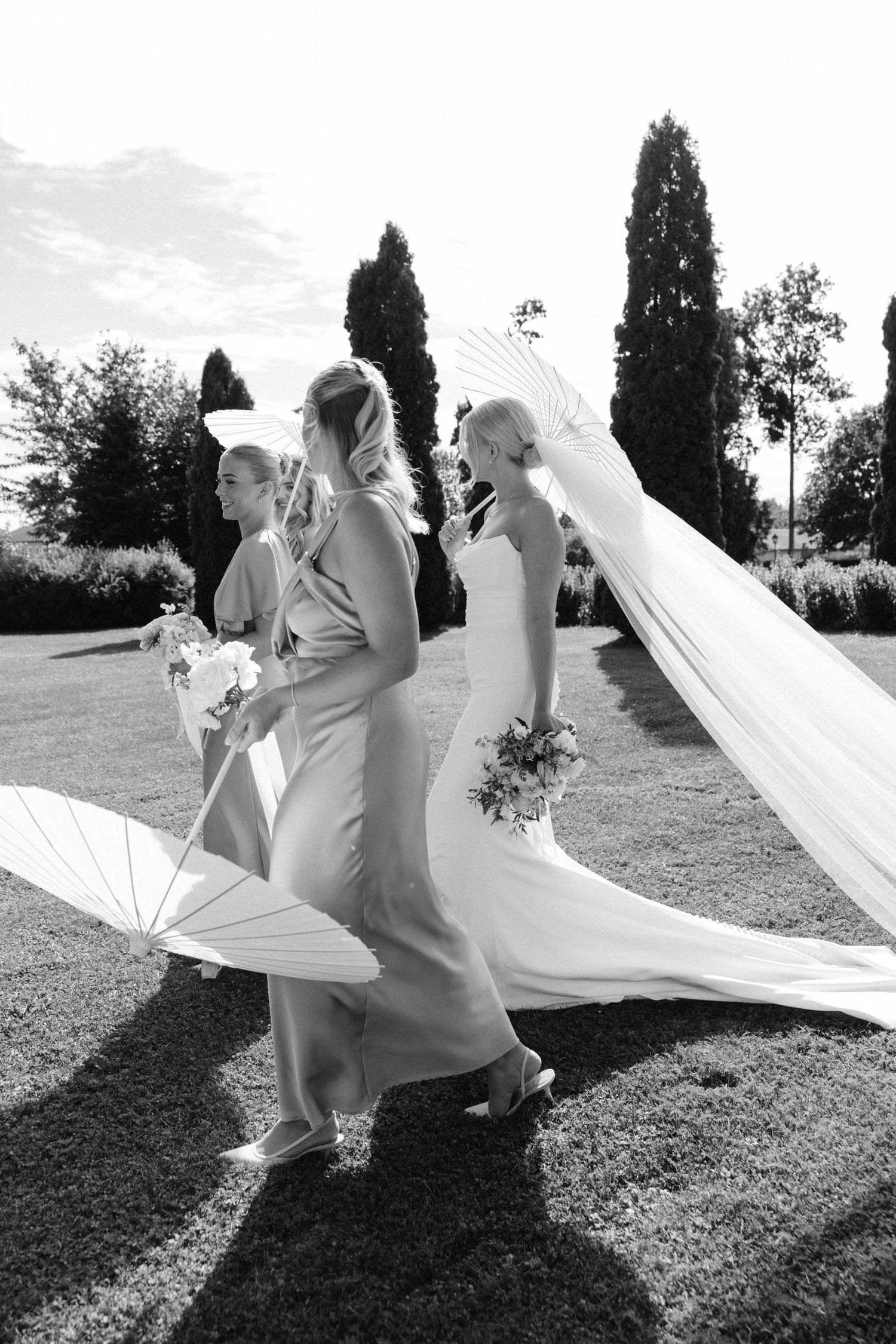 A dreamlike sequence shows a flowing white wedding dress and veil billowing in the wind across a grassy hillside.