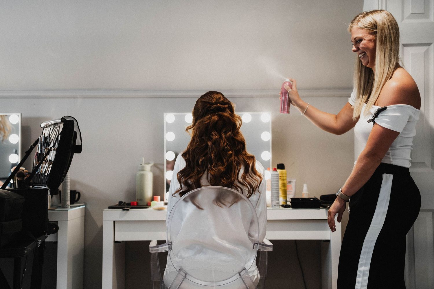 Stylish black stiletto heels being photographed for social media content in a bright white studio setting.