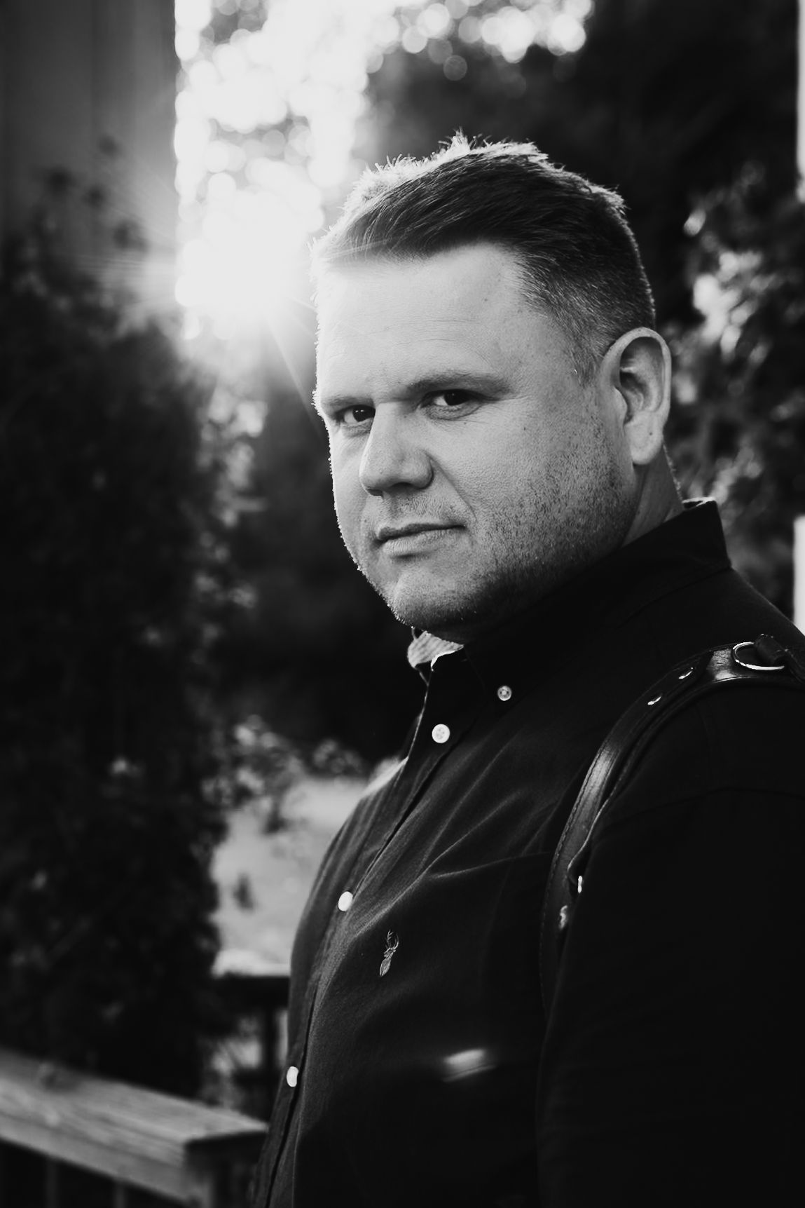 A series of moody black and white portrait photographs showing different facial expressions and angles.