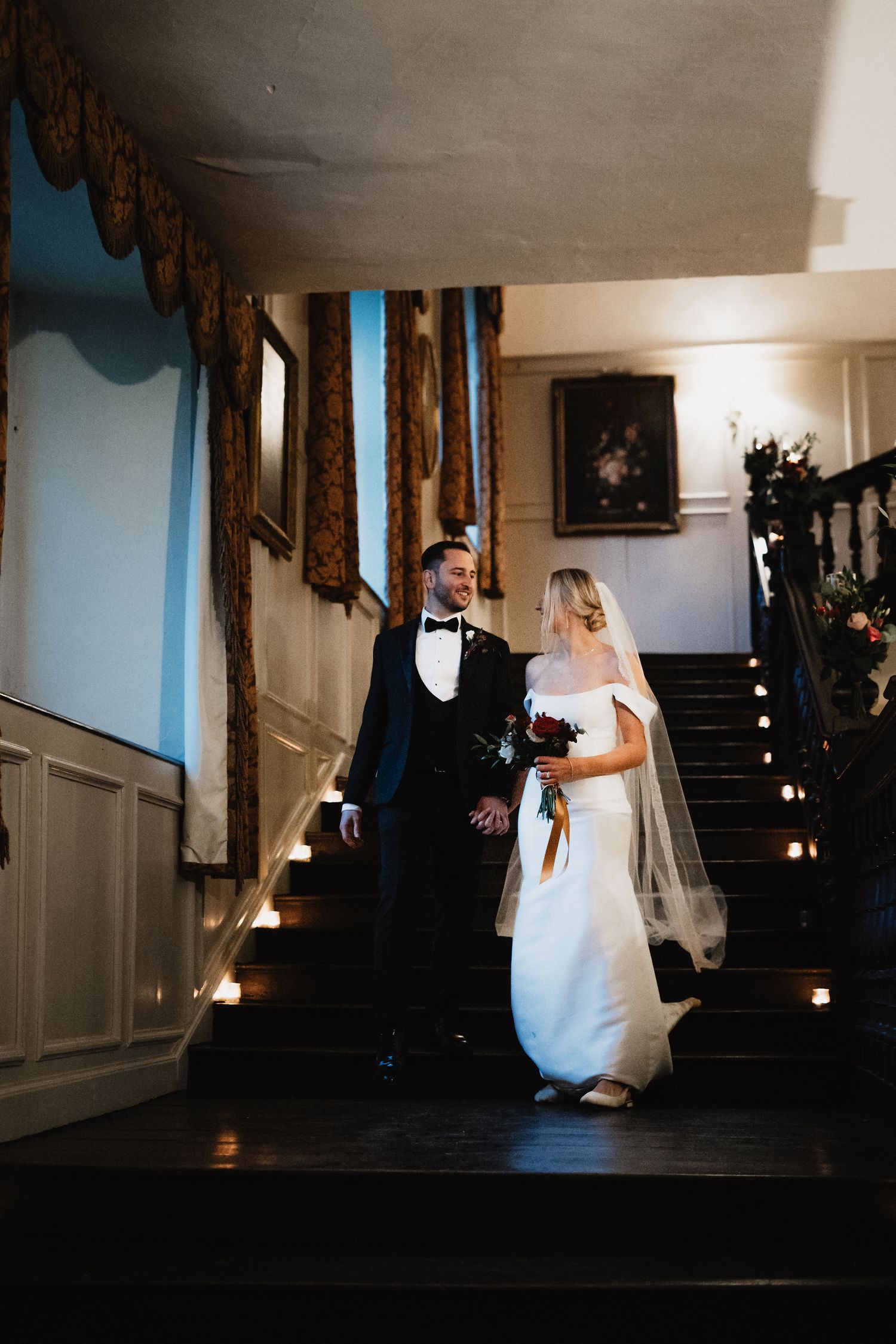 A sequence of five dark atmospheric wedding photos showing silhouettes in a dimly lit hallway with stairs.