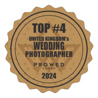 A circular brown badge designating Top #4 United Kingdom's Wedding Photographer ProWed Award for 2024.