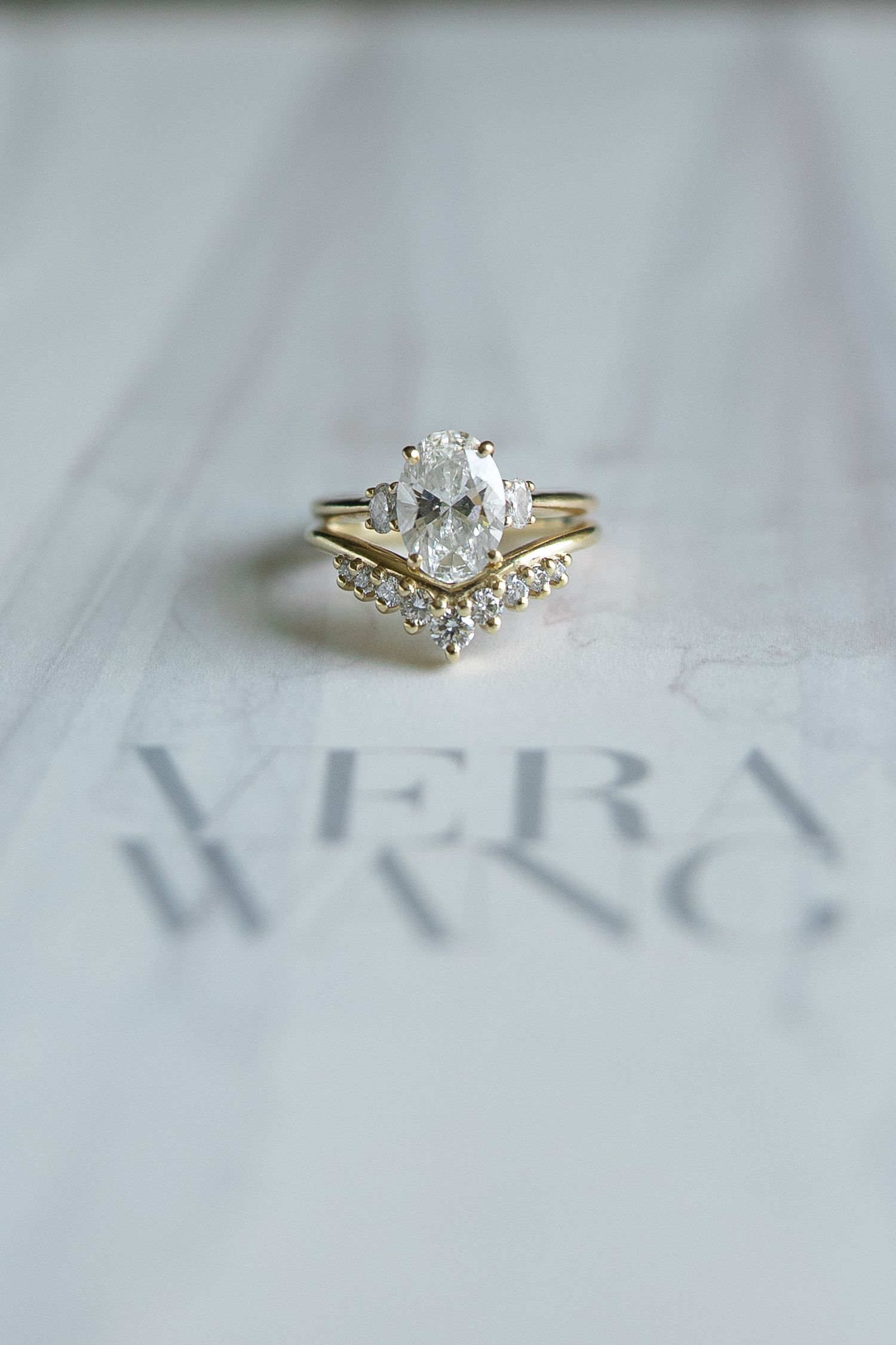 Close-up view of an elegant diamond engagement ring with a marquise-cut center stone set in a delicate gold band.