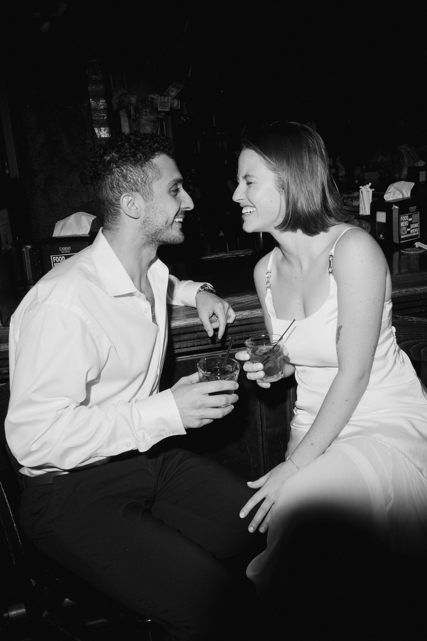 Black and white photo sequence showing a romantic couple in conversation at a dimly lit venue.