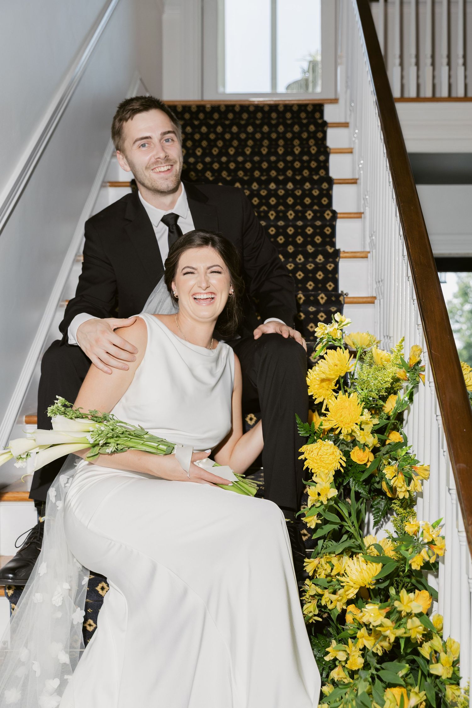 Elegant wedding portraits with bright yellow floral arrangements against a white staircase backdrop, Flash Photography at Westwood Lodge, NC