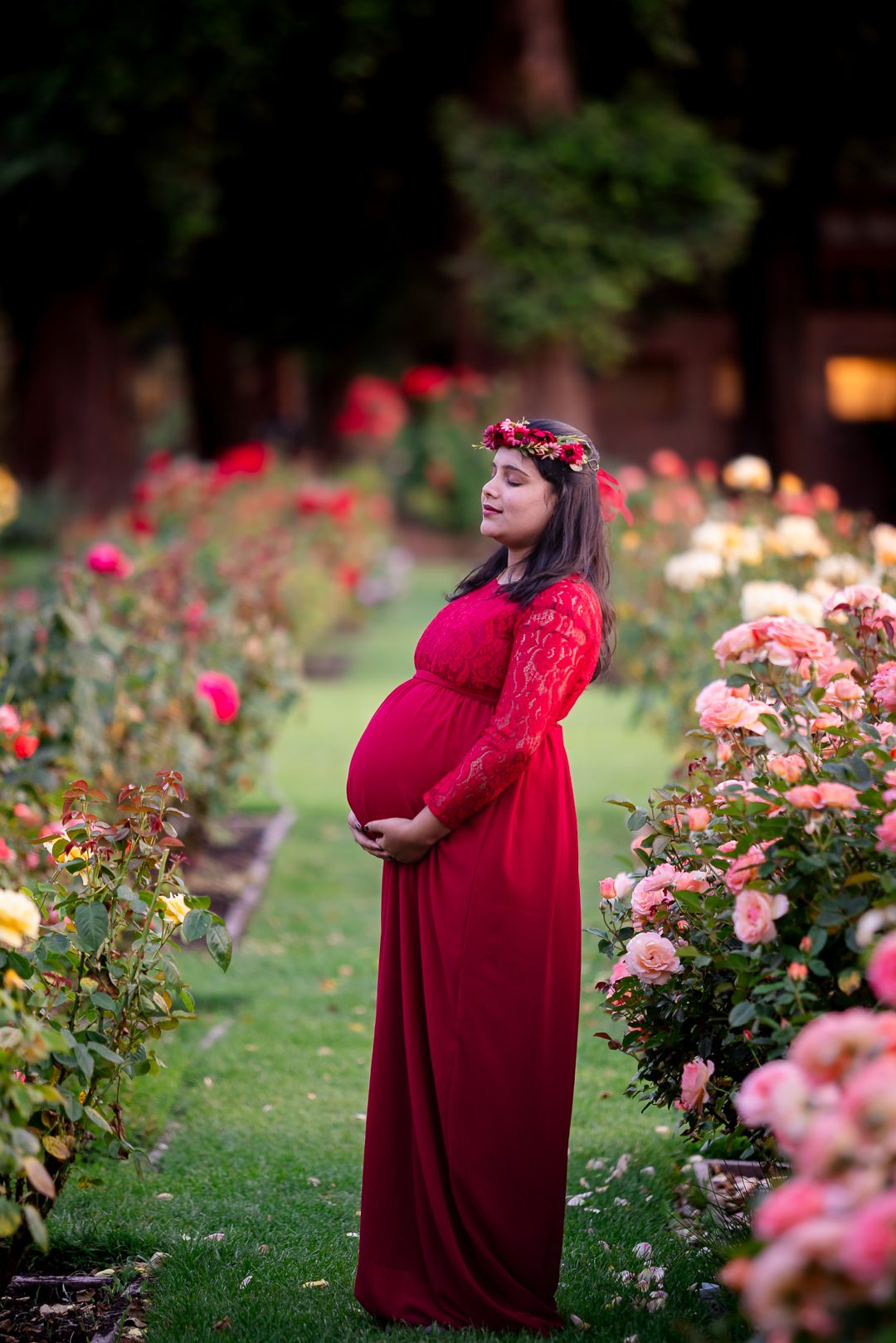 Maternity photo pose idea in full bloom at San Jose Rose Garden of a mother embracing her journey wear a flower crown by pixels by pari