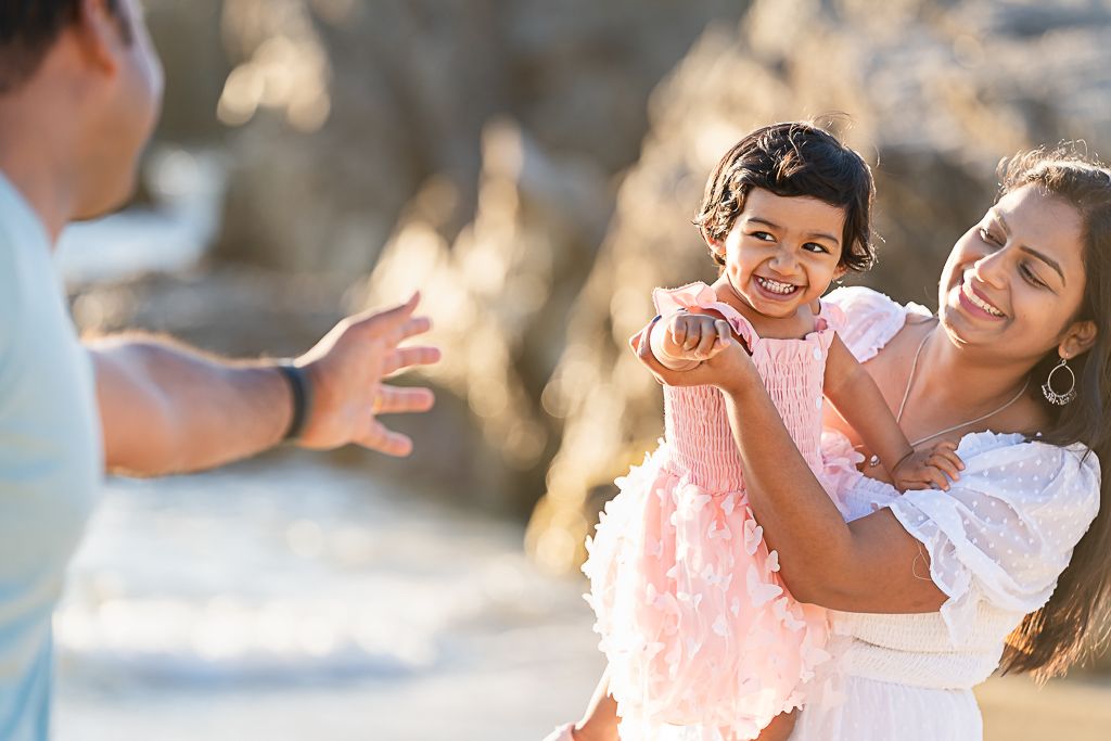 Mother holding baby in golden hour light at outdoor family photo session by Tracy, CA  photographer