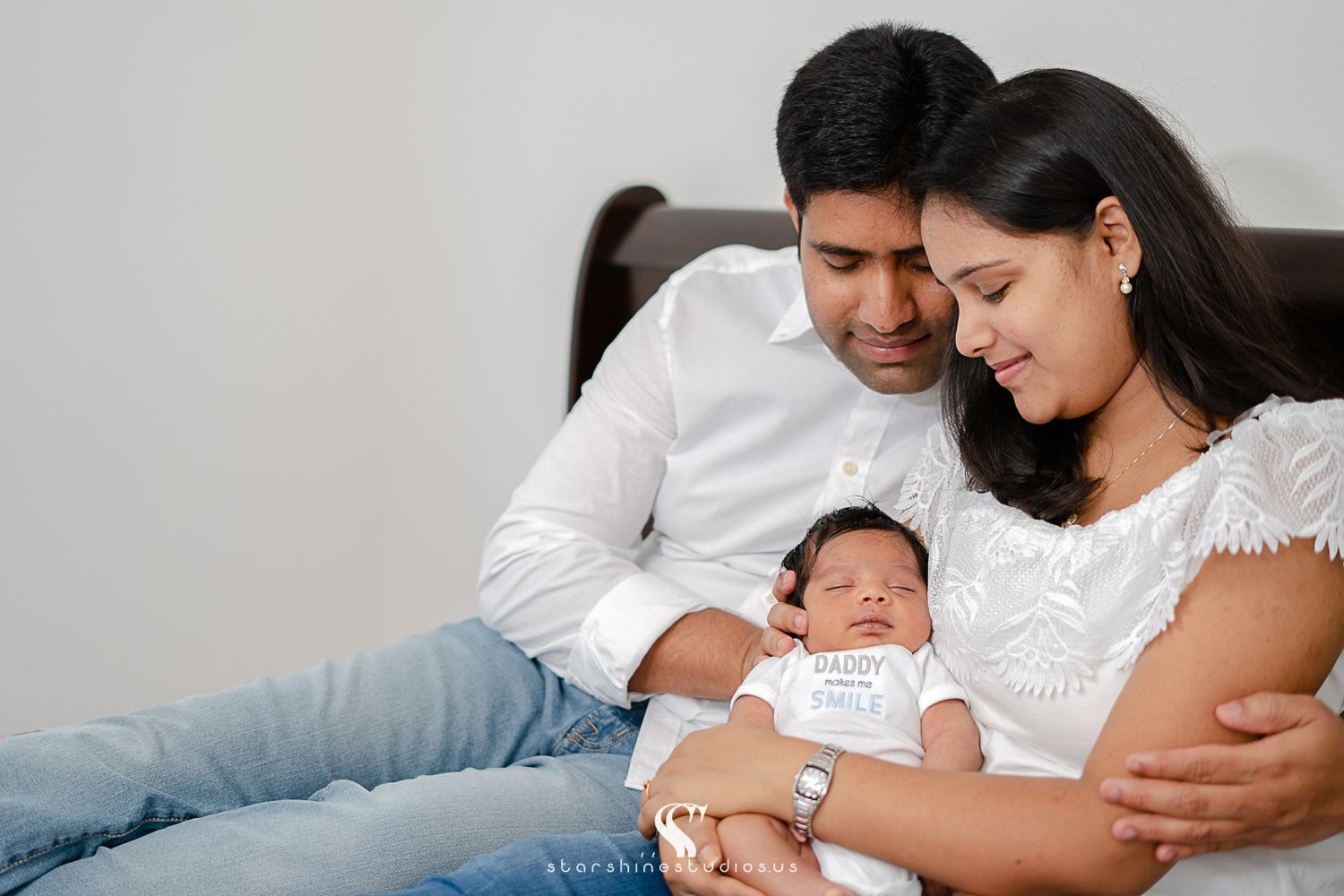 New parents admiring their newborn baby girl in a lifestyle newborn photo session
