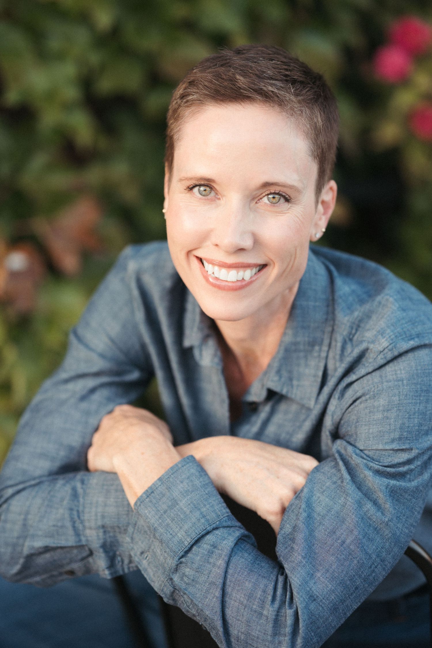 Professional portrait of an adult woman wearing denim in natural light.