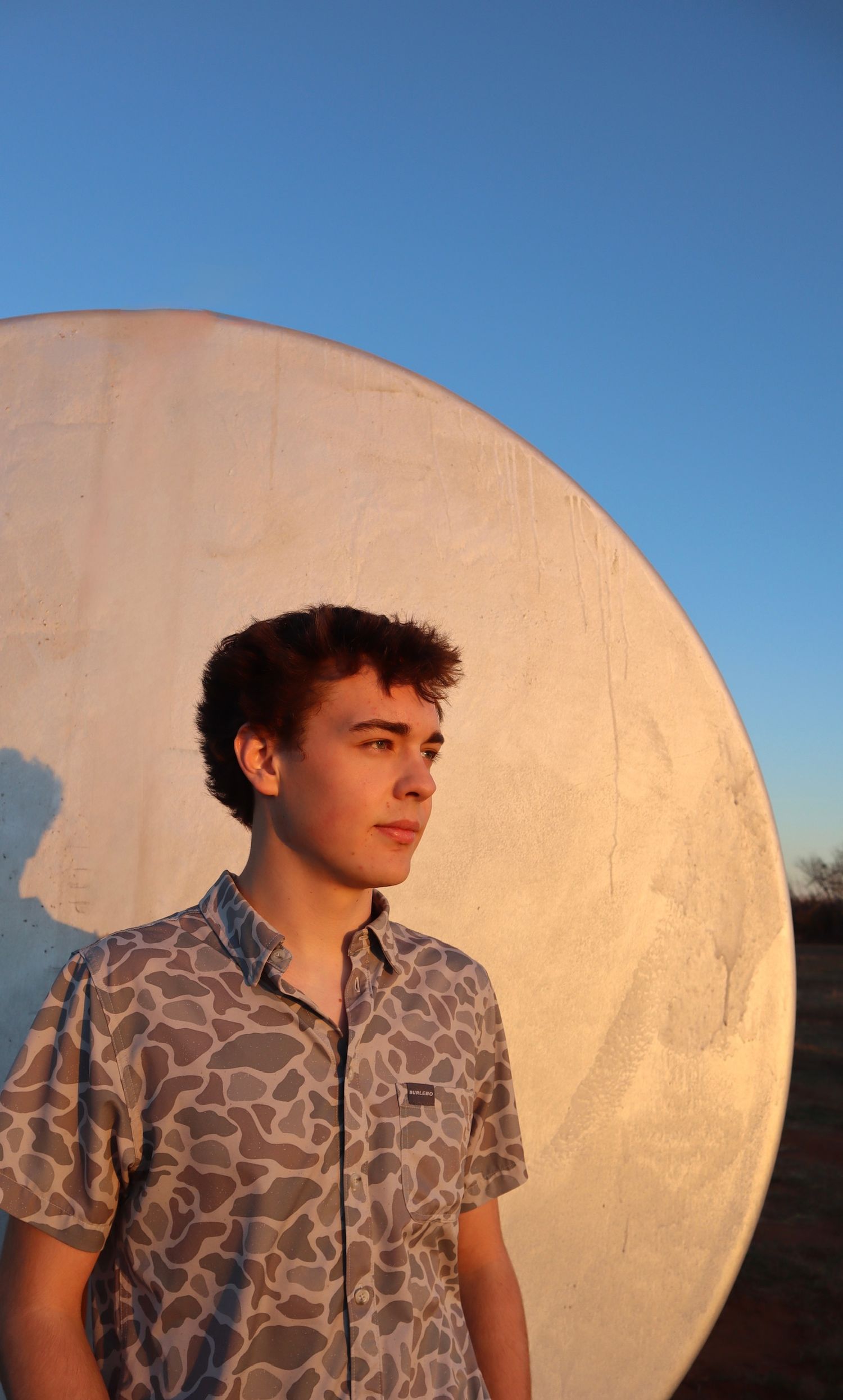 A series of photos showing a person in a patterned shirt against a bright white circular backdrop at sunset.