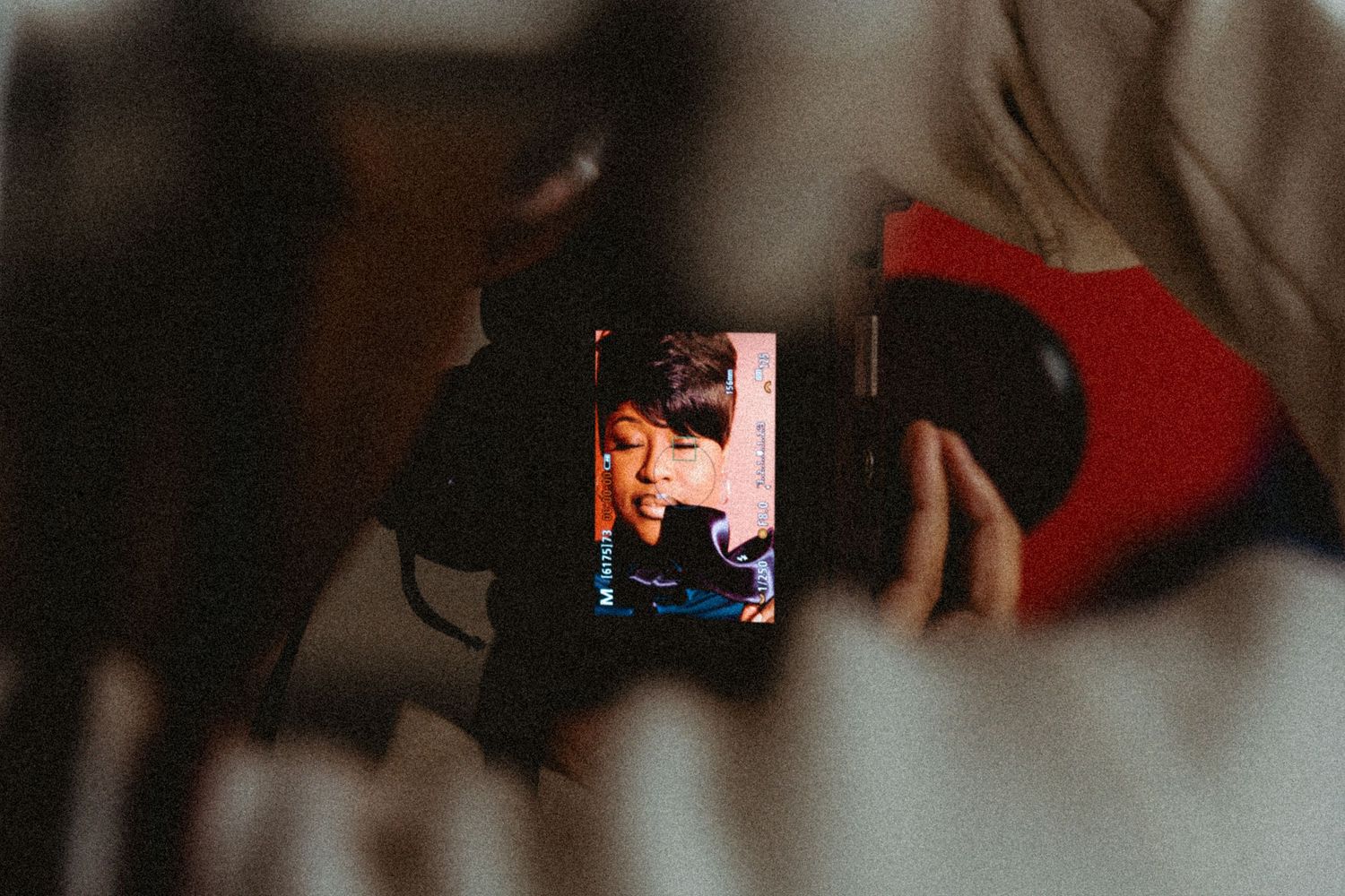 A close-up of a camera screen showing a person being filmed during a video production.