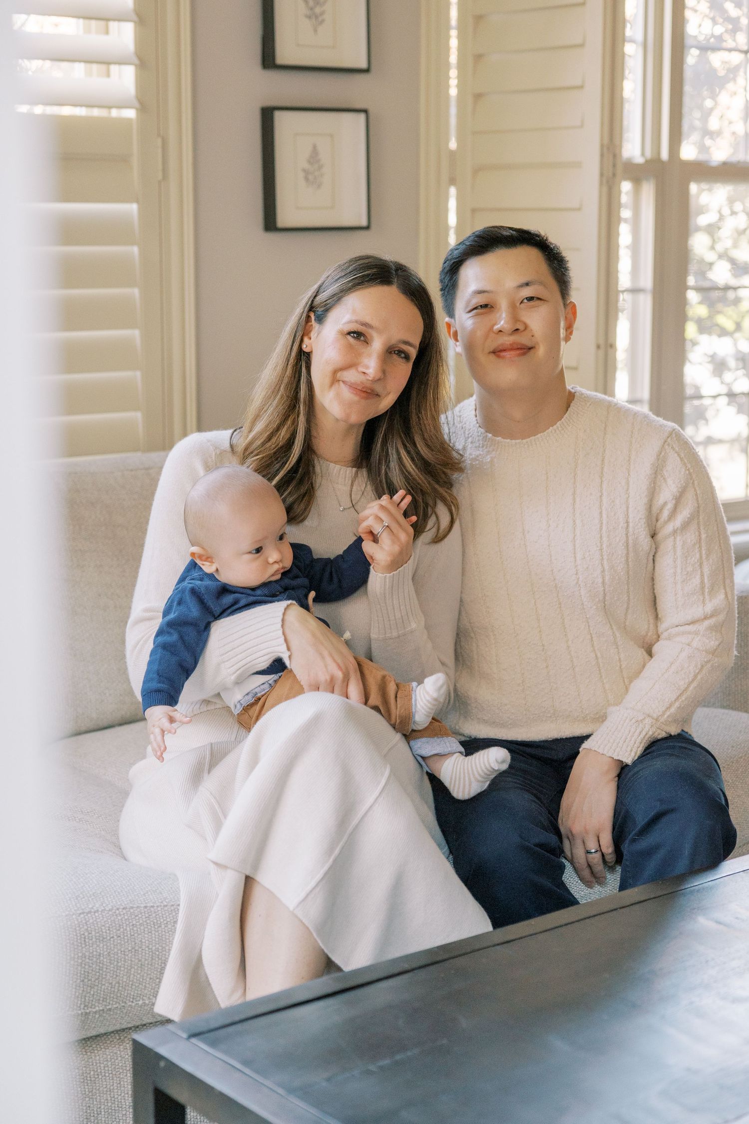 Family portrait in bright indoor setting with natural window light.