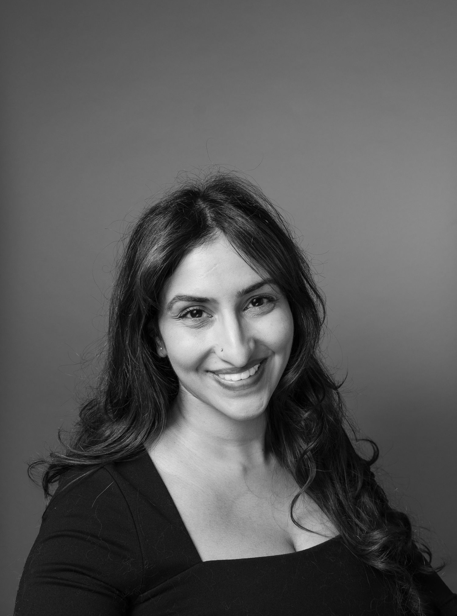A series of black and white portrait photos showing a person with dark hair wearing black against a light background.