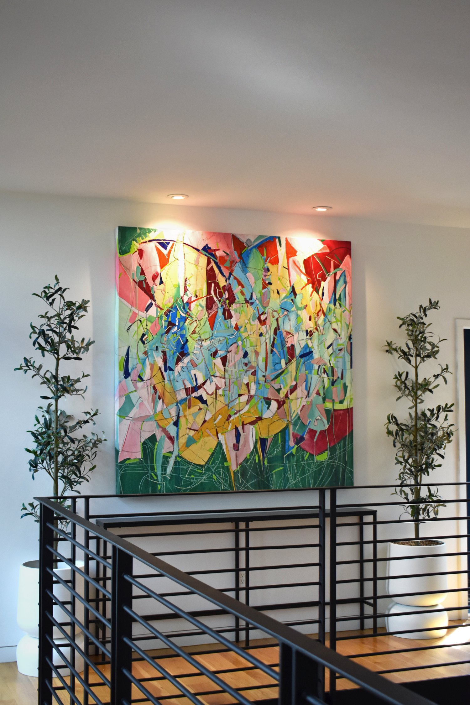 Residential staircase landing in downtown San Antonio with large-scale curated abstract artwork