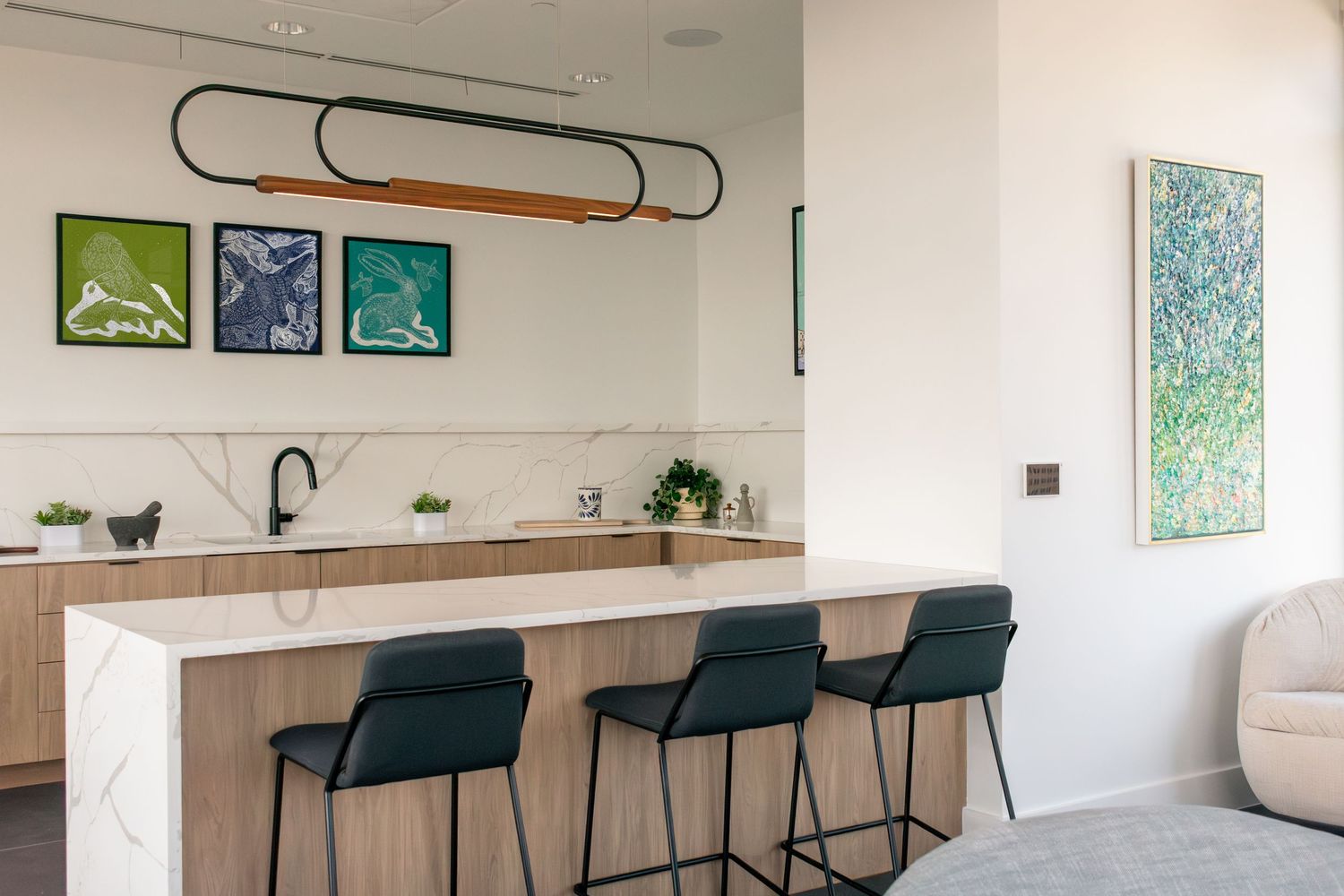 Modern kitchen interior at The Continental Residences in downtown San Antonio with curated artwork and pendant lighting