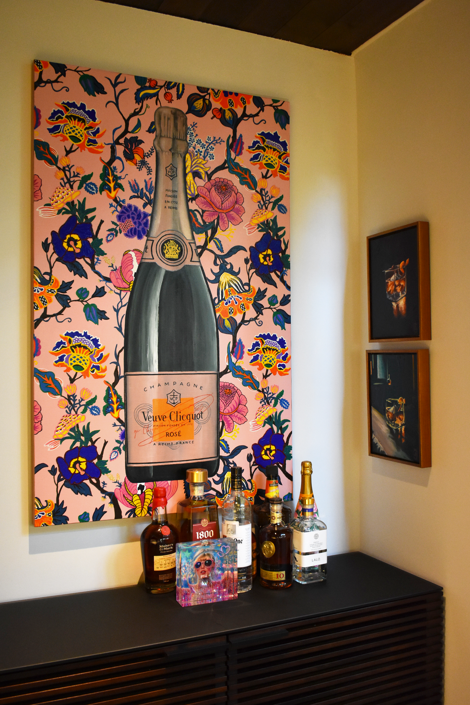 Residential home bar area in downtown San Antonio with large curated champagne bottle artwork