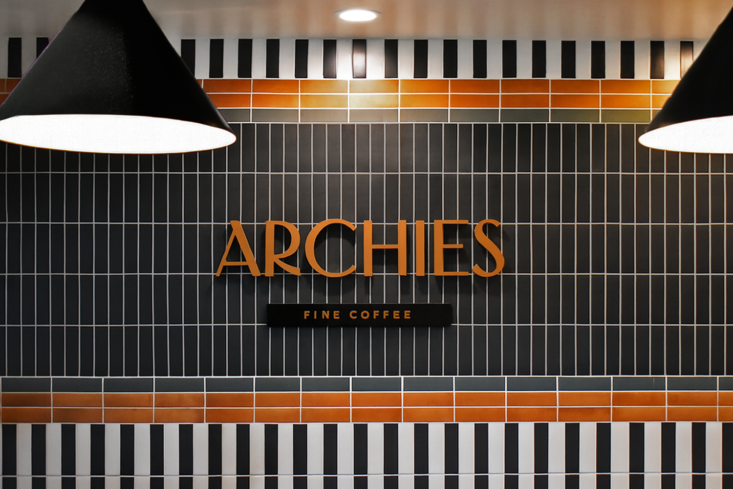 Archies Fine Coffee lounge interior in San Antonio with geometric tile wall and pendant lighting