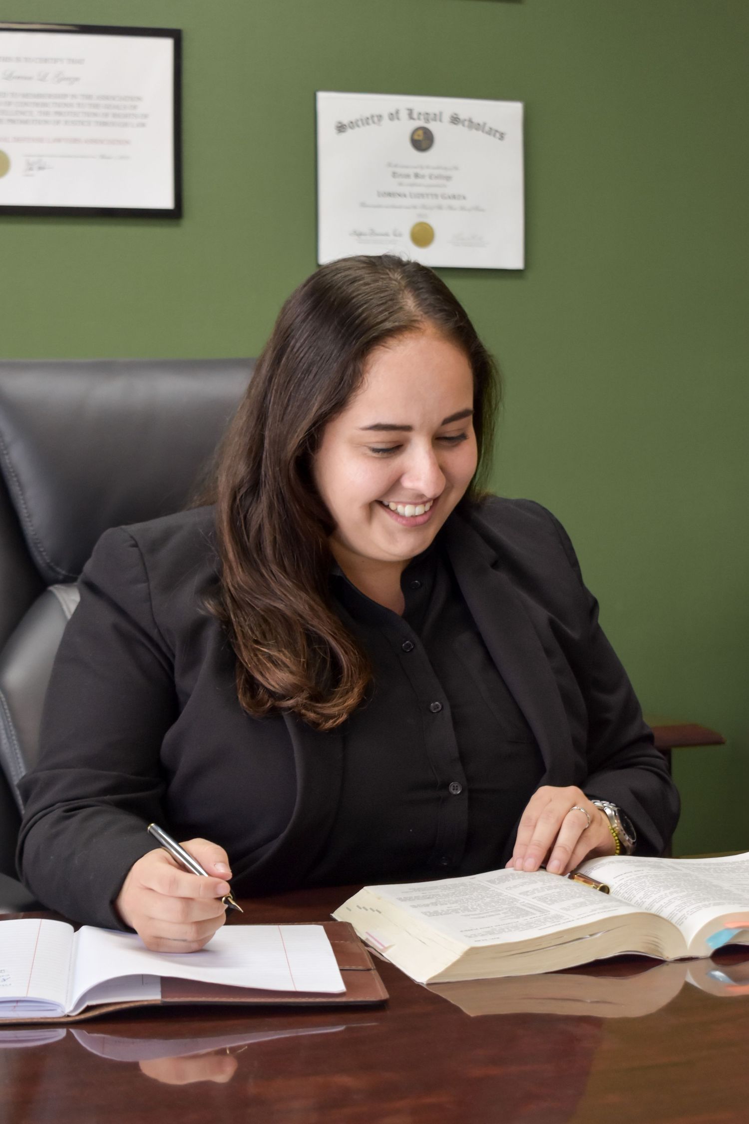 Professional office portrait of San Antonio attorney reviewing legal documents at desk