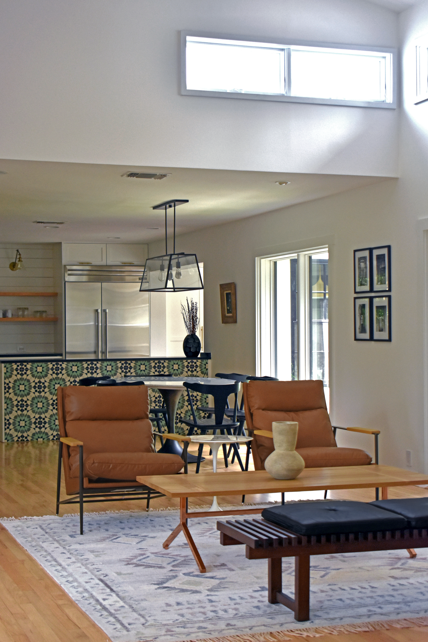 Residential open living and dining area in San Antonio with mid-century modern furniture and patterned tile