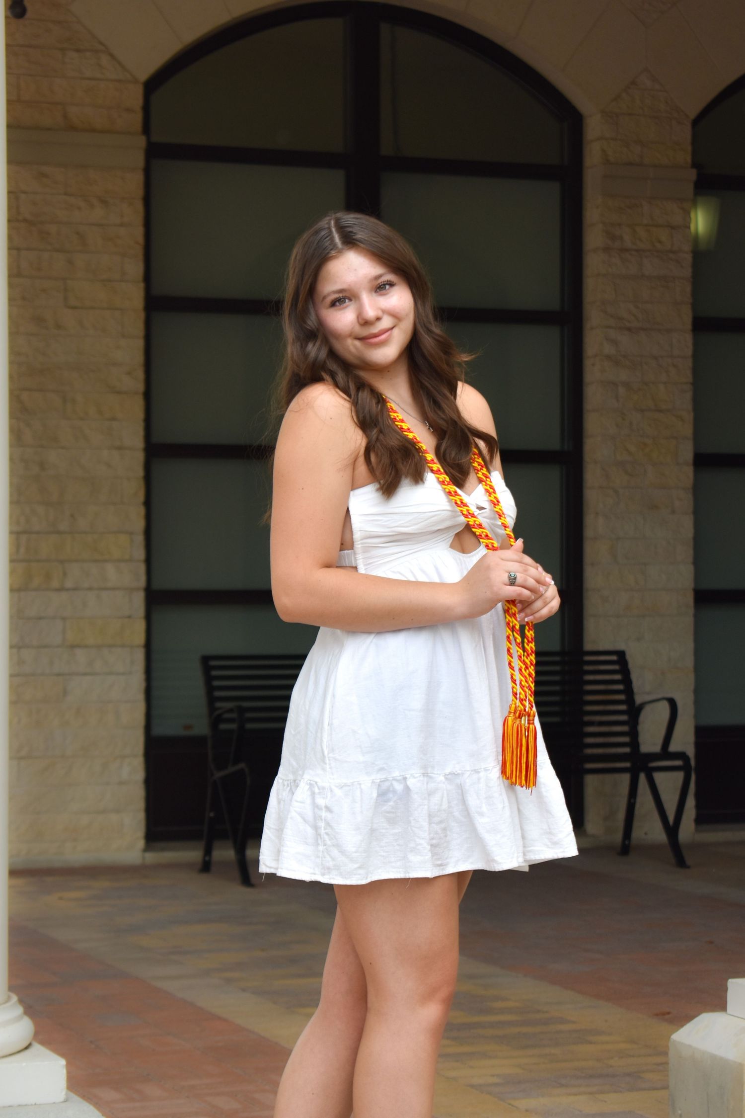 High school graduation portrait at The Eilan Hotel in San Antonio in white dress with honor cords