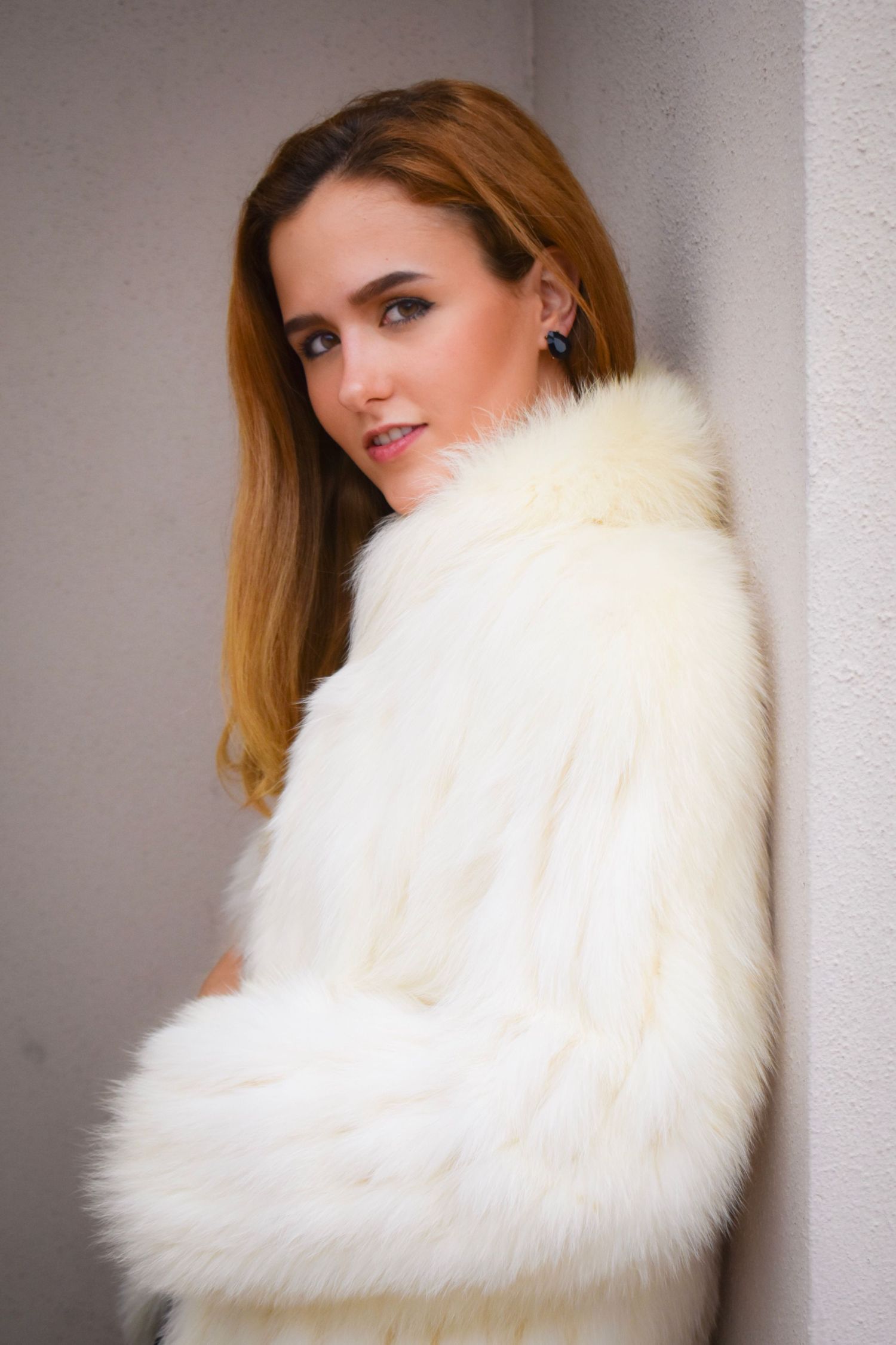 Portrait photography in Brownsville Texas of woman in white faux fur jacket close-up portrait