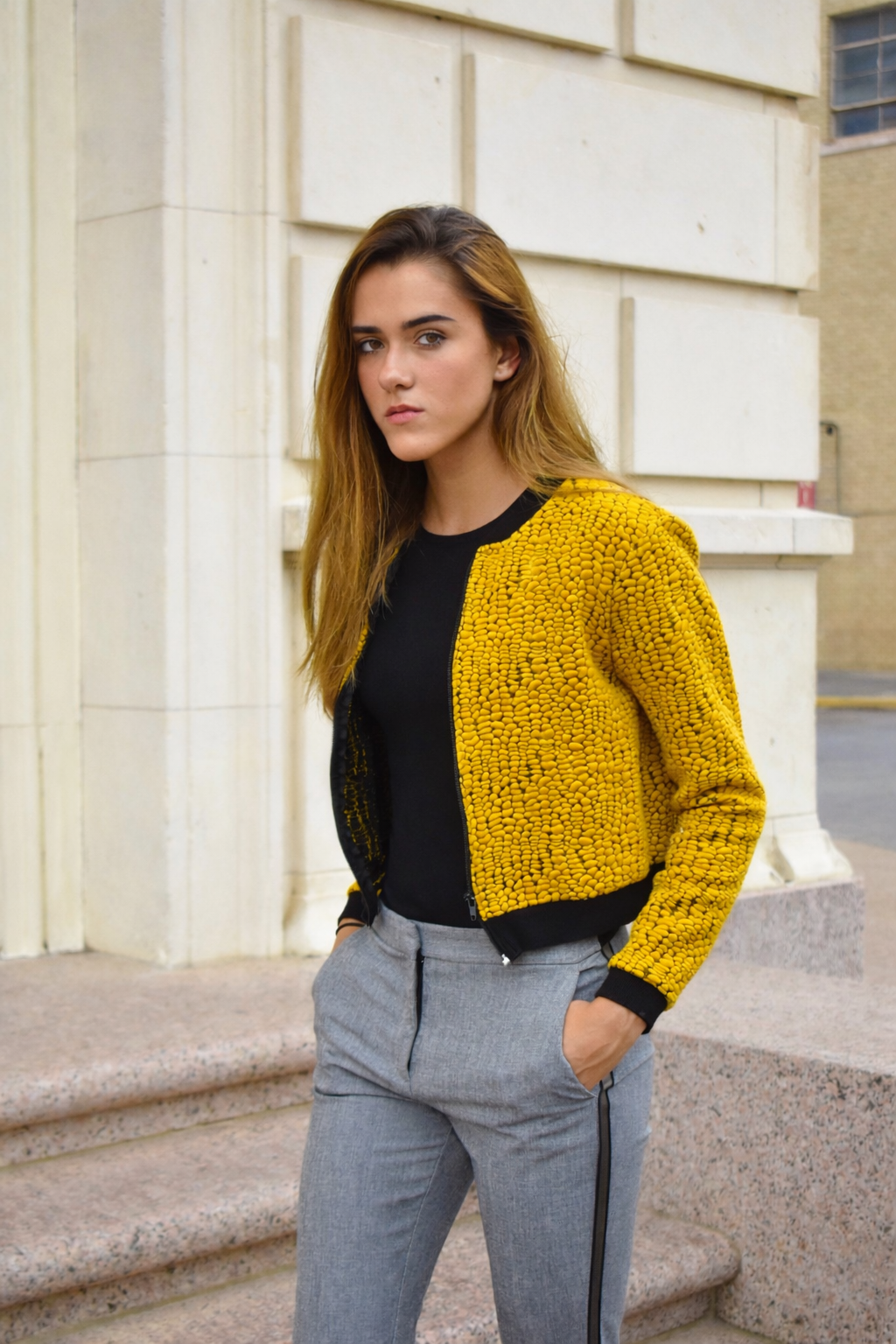 Portrait photography in Brownsville Texas of woman in yellow knit cardigan outdoors