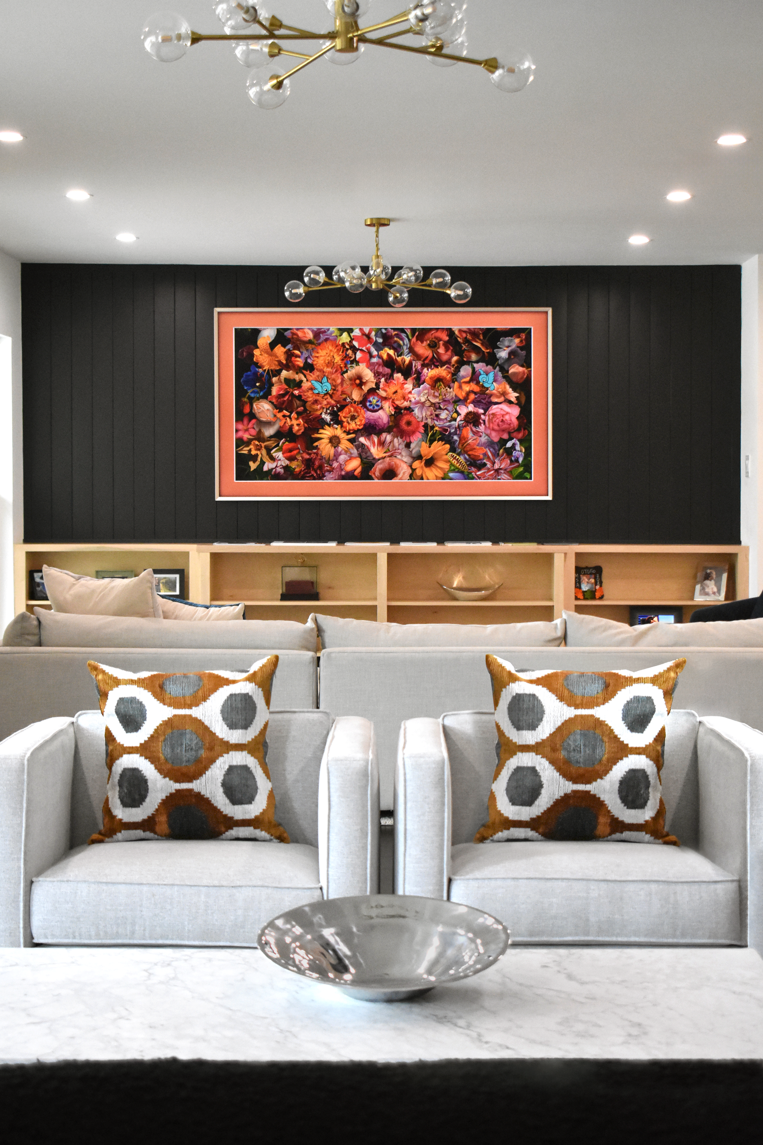 Residential living room interior in San Antonio with gray sofas and large floral curated artwork