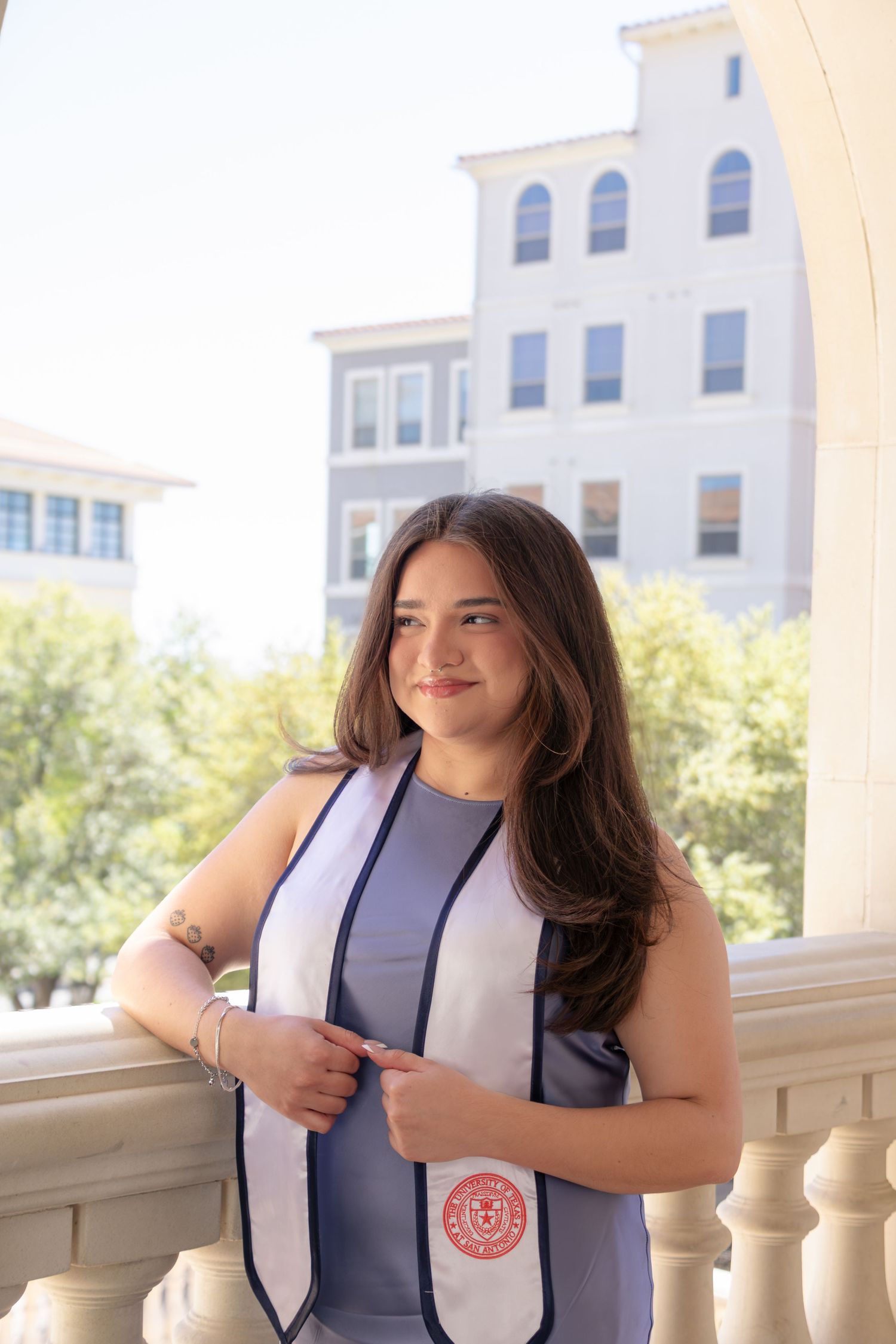 UTSA graduation portrait at The Eilan Hotel in San Antonio wearing graduation stole