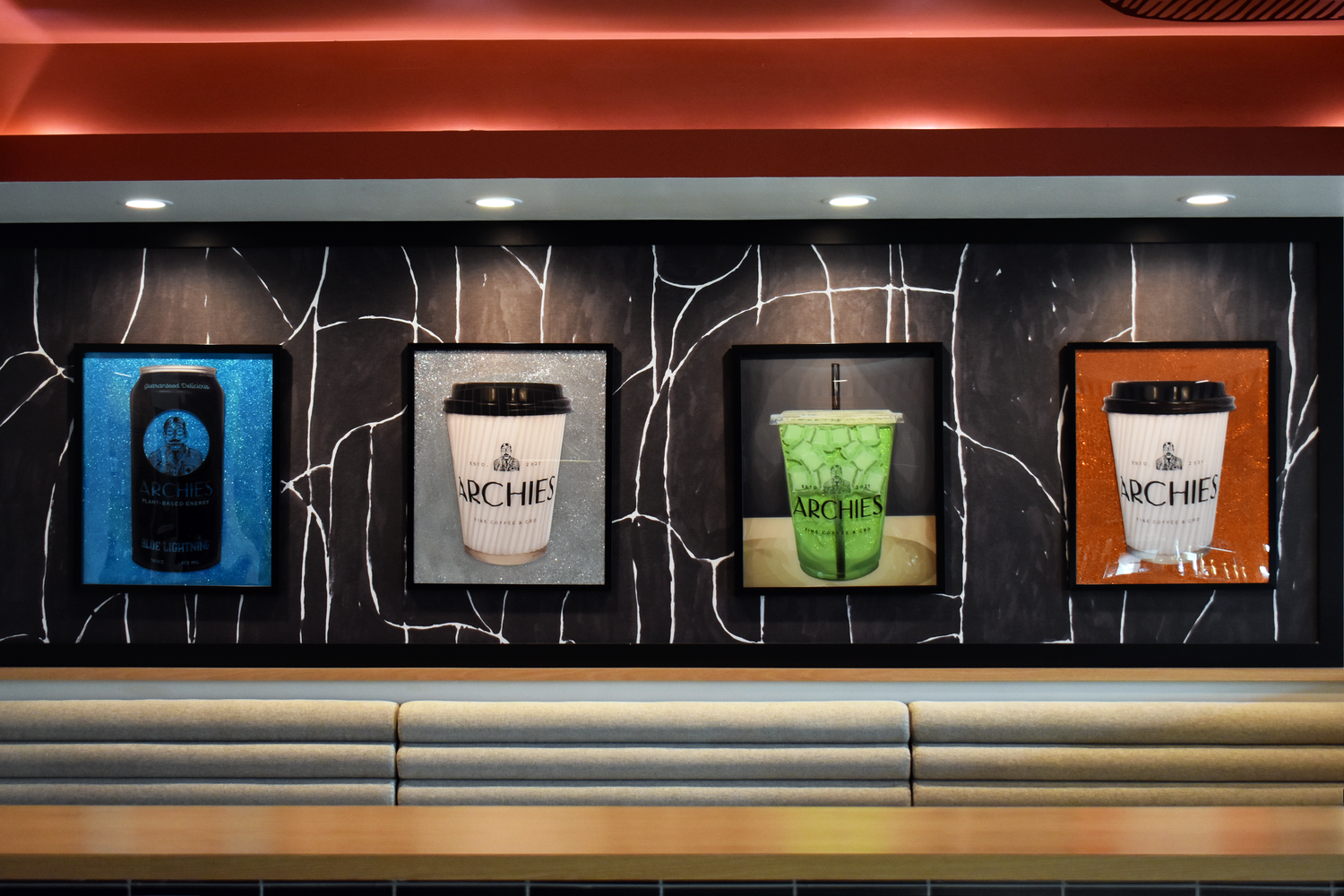 Archies Fine Coffee lounge in San Antonio with curated coffee cup artwork display on marble wall