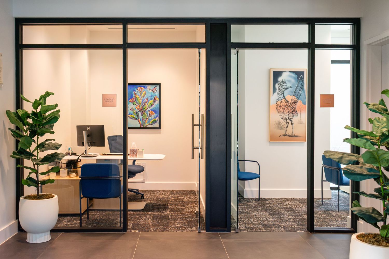 Glass-walled office interior at The Continental Residences in downtown San Antonio with curated artwork