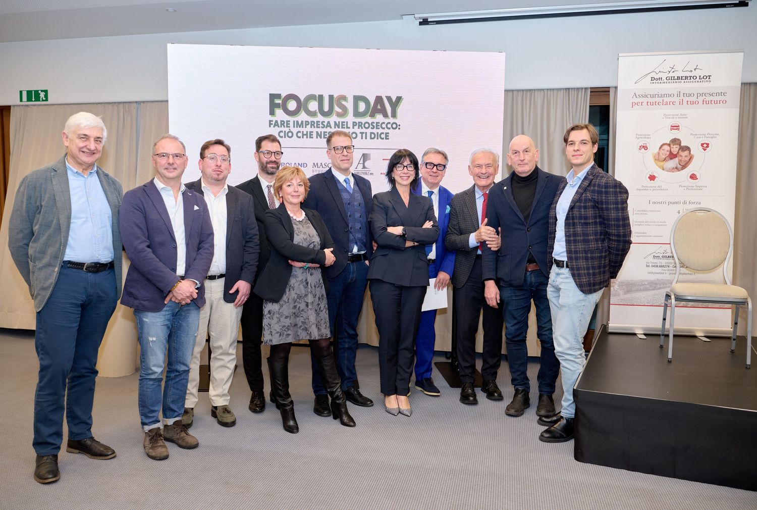 Group of ten business professionals posing together at a Focus Day industry conference event.