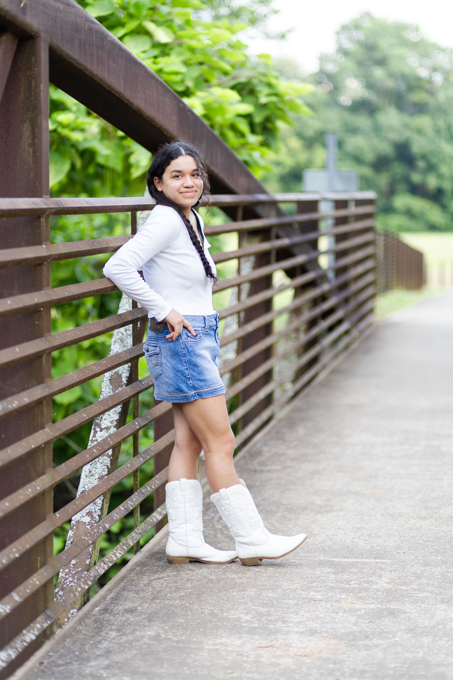 High school senior leaning back on bridge.