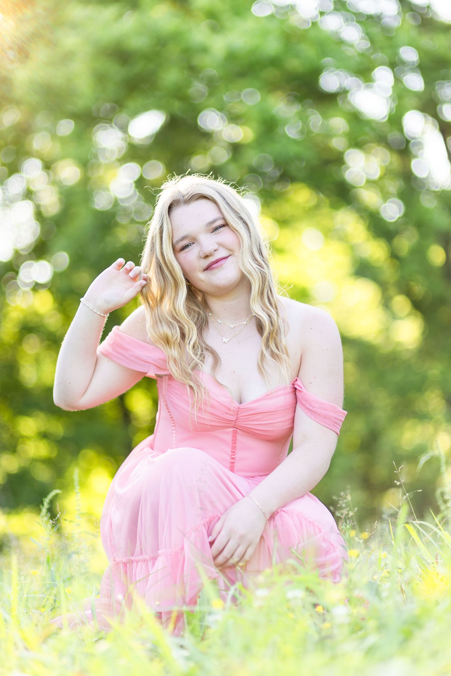 High school senior looking at camera and playing with hair.