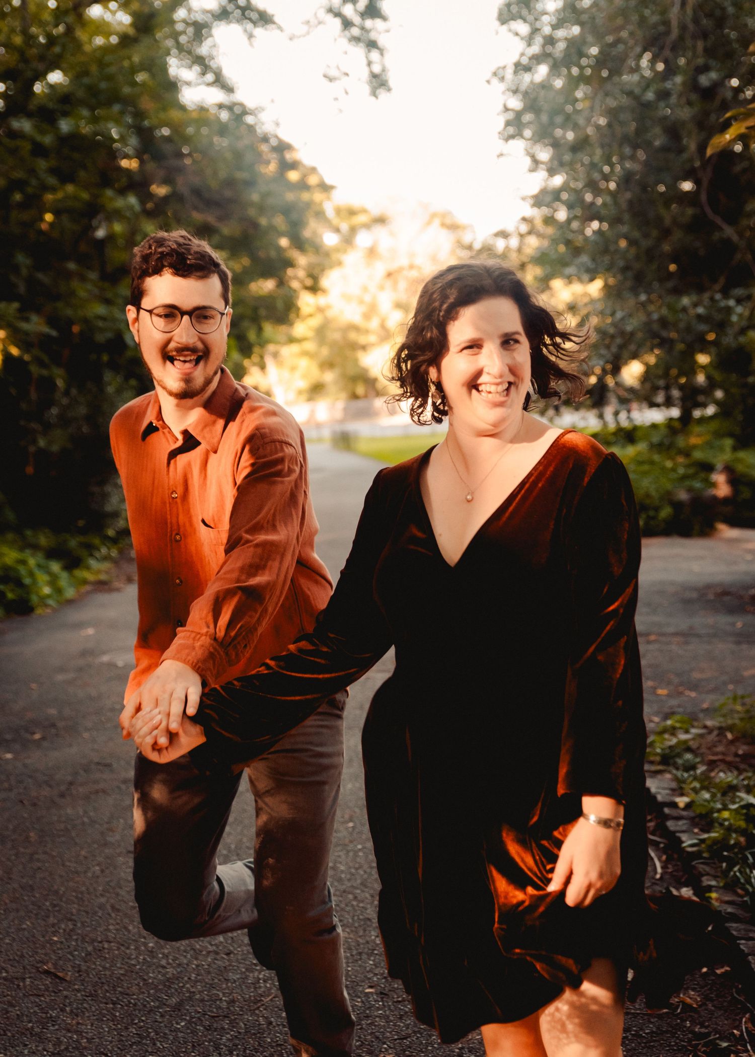 A couple running hand in hand in Fort Tryon Park in New York City