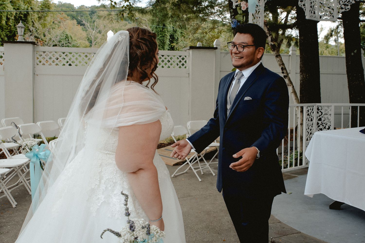 The first look between a bride and groom. As the bride approaches, the groom is full of joy seeing his soon-to-be-wife in her dress.