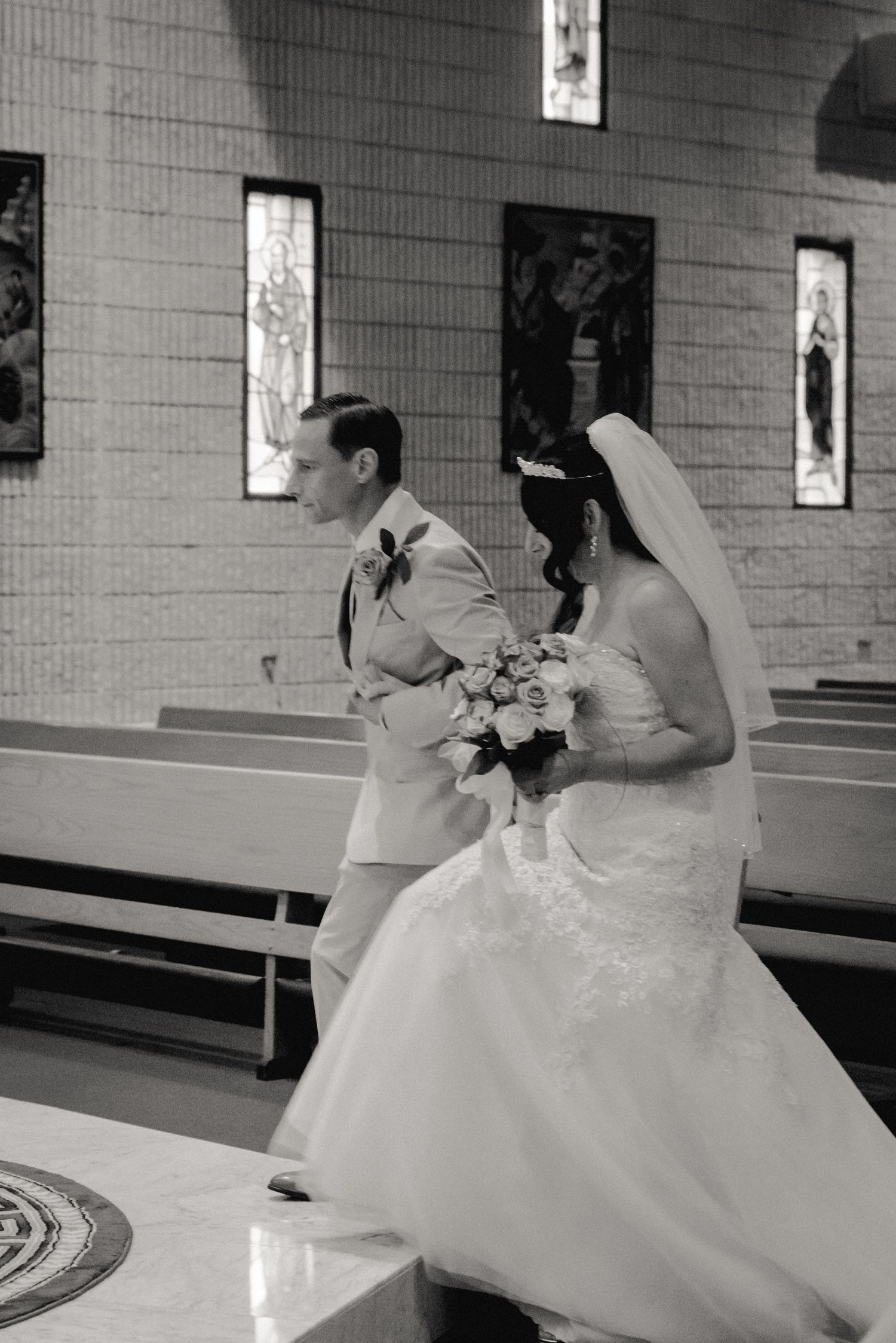 A timeless black and white photo of the bride and groom approaching the alter during their church ceremony in Vestal, NY.