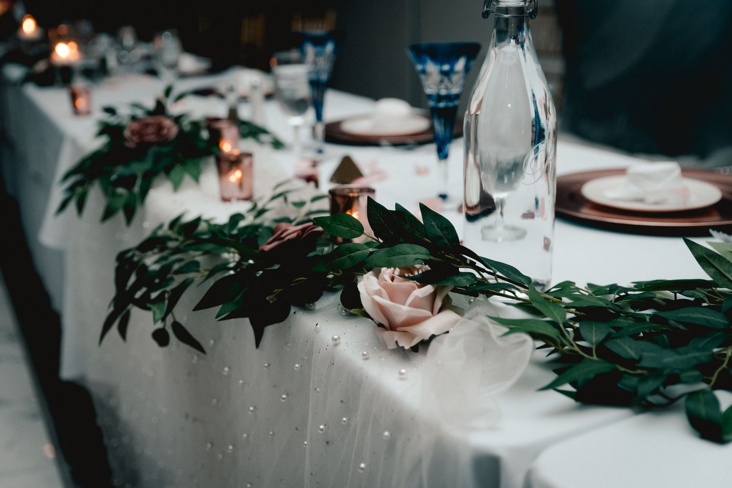 Gorgeous table setting with roses and ornate dishes for the bride and groom at their wedding at the Riverdale in Endicott, NY.