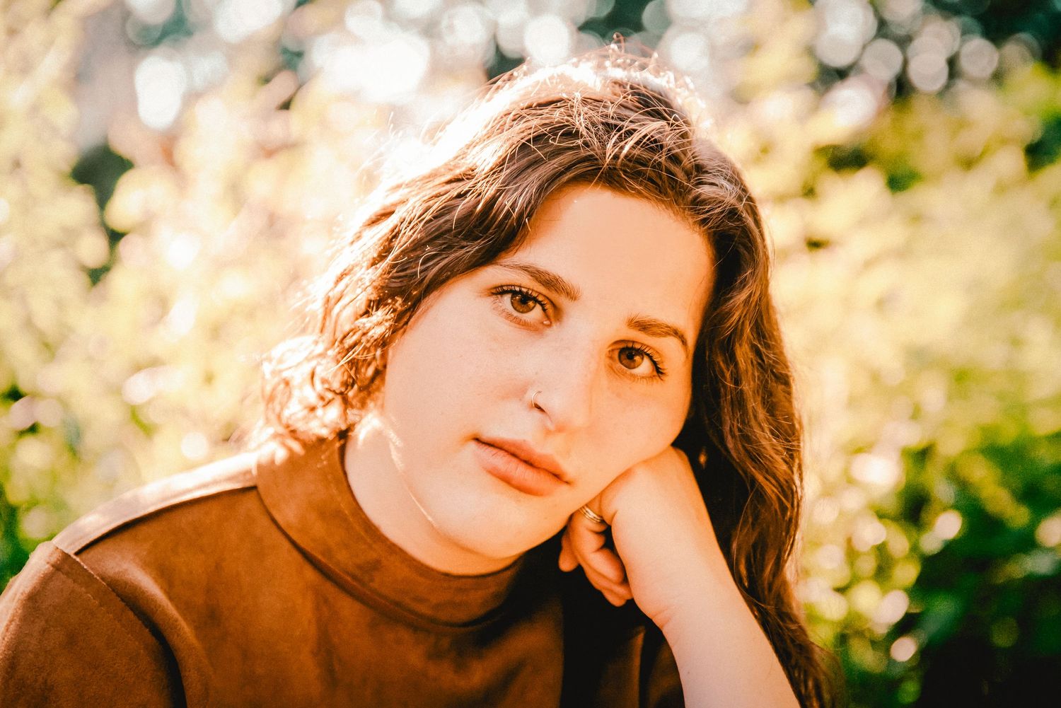 Prospect park portrait session at golden hour. Close up portrait of woman with trees in the background.